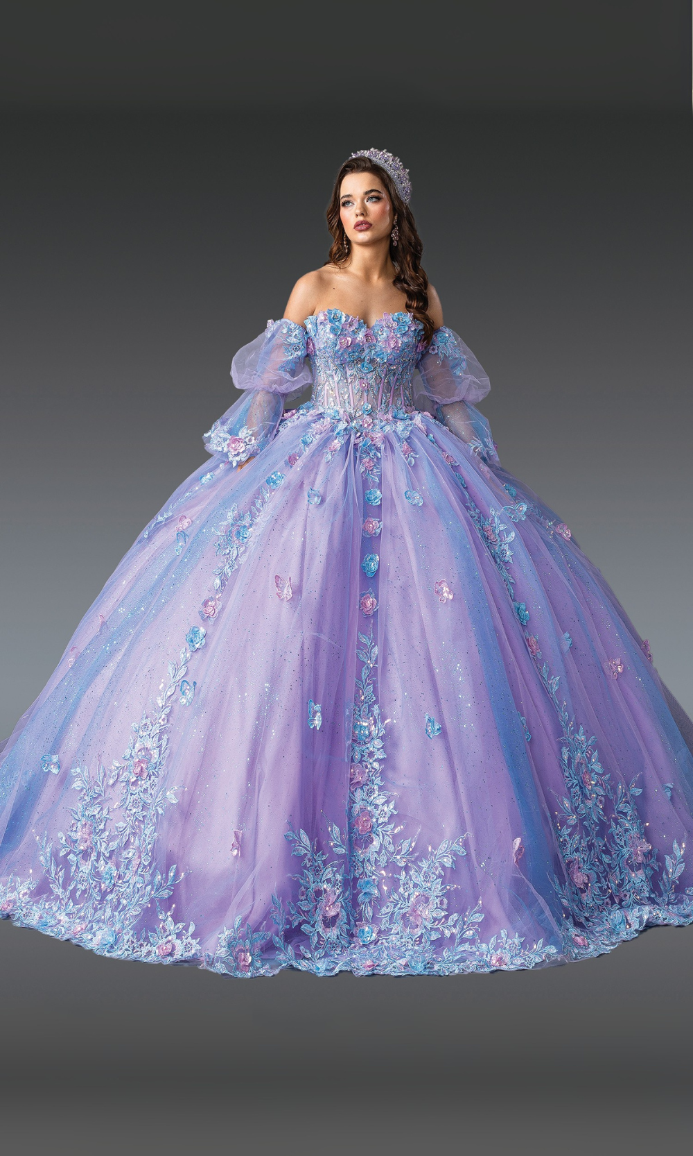 Woman wearing a purple and blue floral ball gown against a gray background