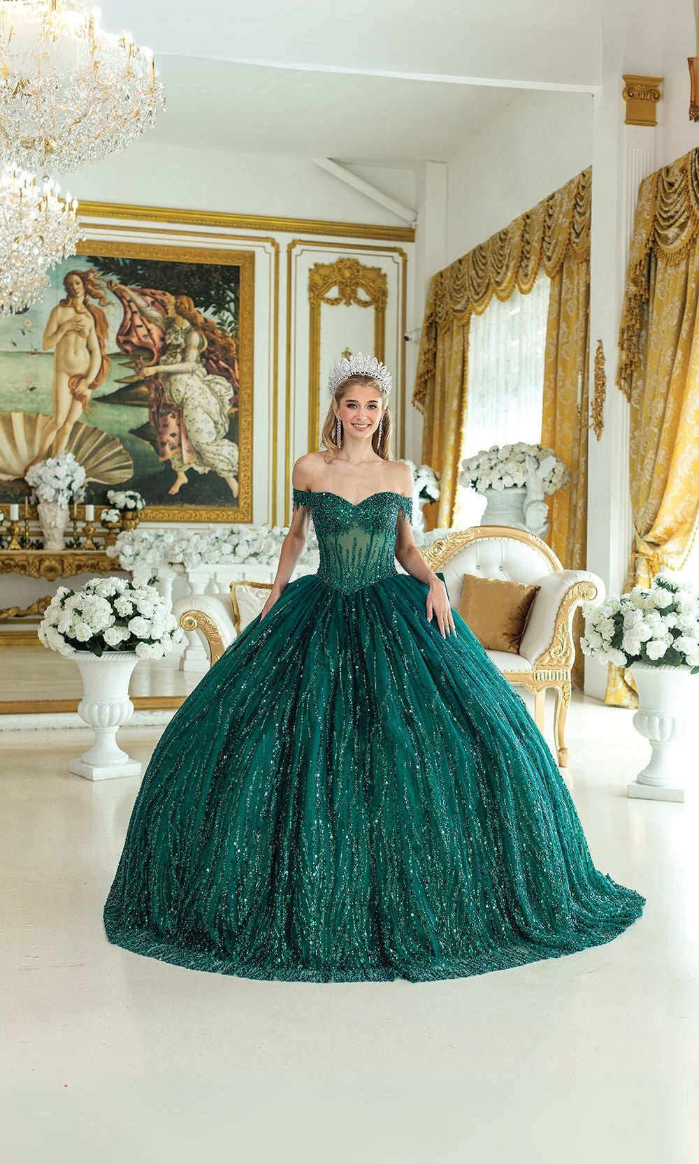 Woman in a green gown standing in an elegant room with decorative elements.