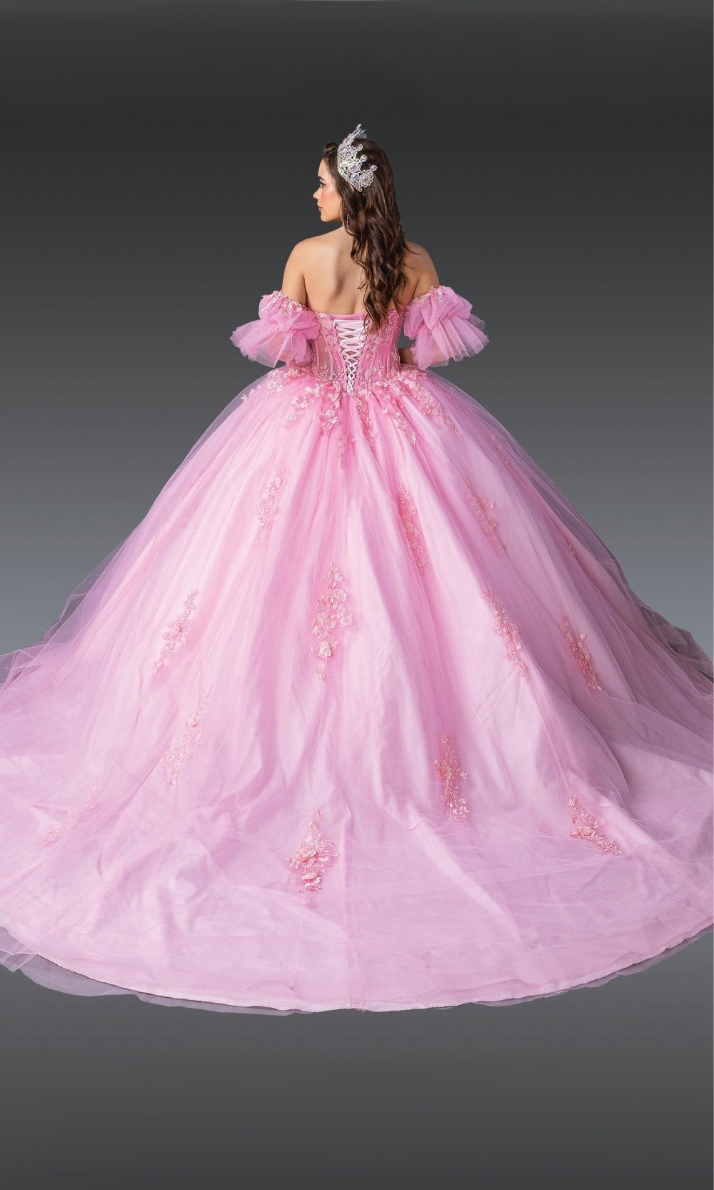 Pink ball gown with floral details on a gray background