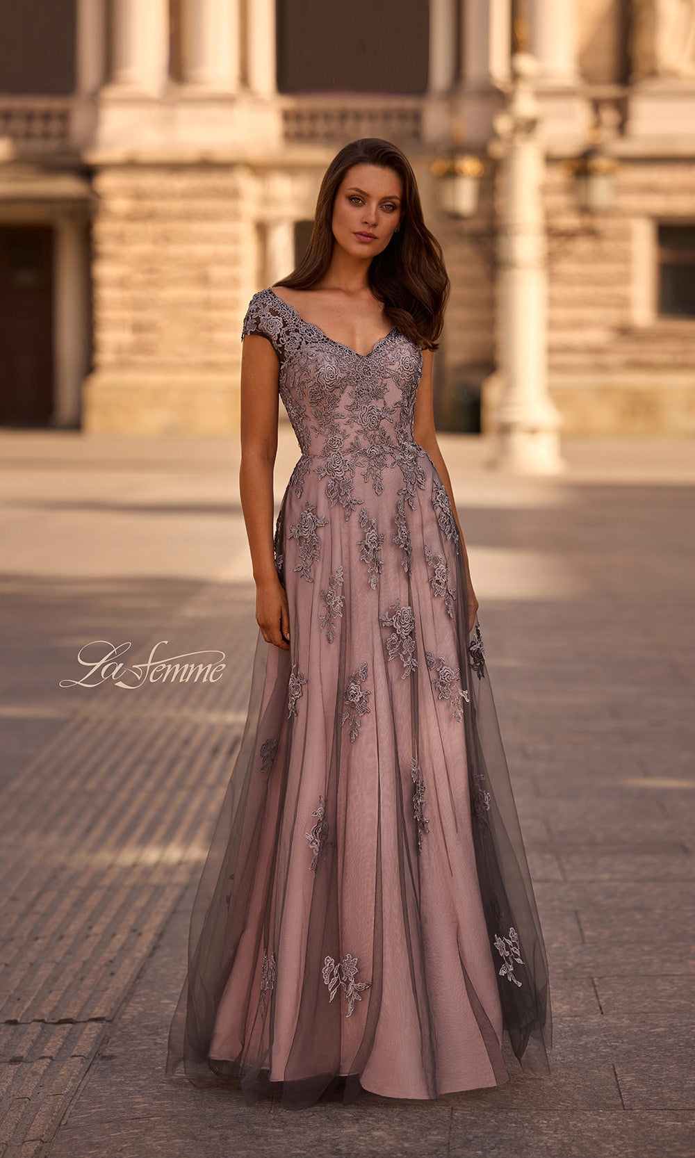 Woman wearing a elegant dress with floral patterns in an outdoor setting.