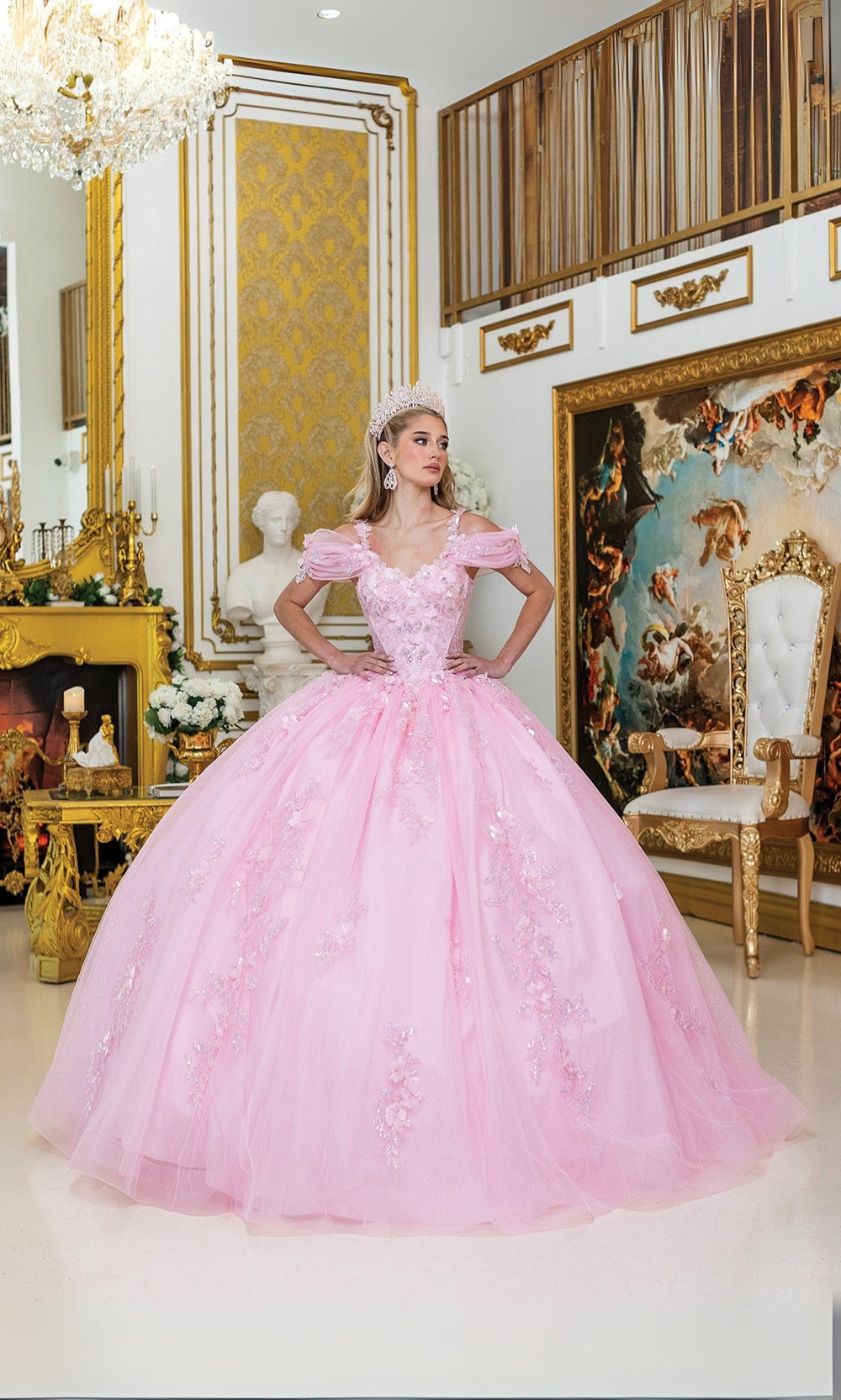 Woman in a pink ball gown standing in an opulent room with gold decor.