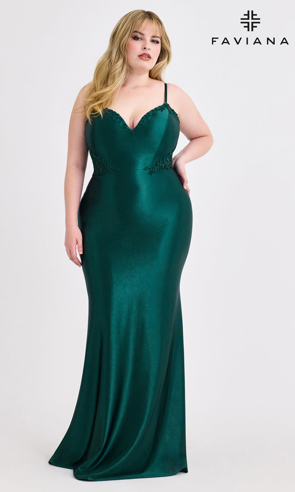 Woman wearing a green evening gown with 'Faviana' branding on a white background