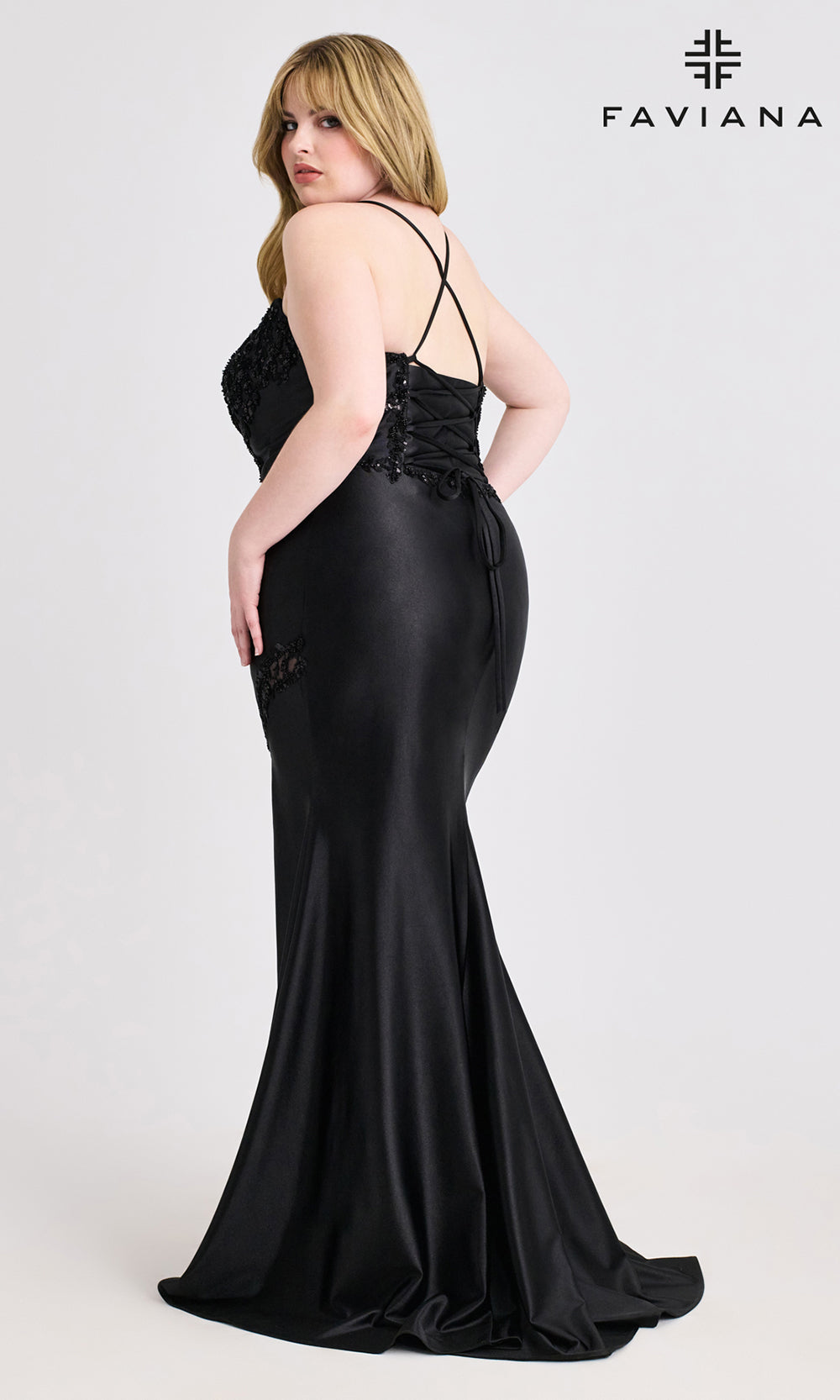 Woman wearing a black evening gown with lace detailing on a white background, branded 'Faviana'.