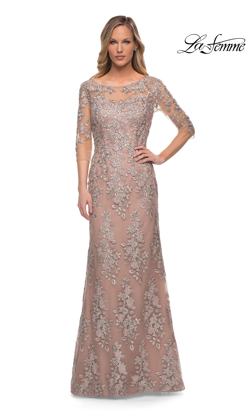 Woman wearing a long, elegant dress with floral patterns on a white background