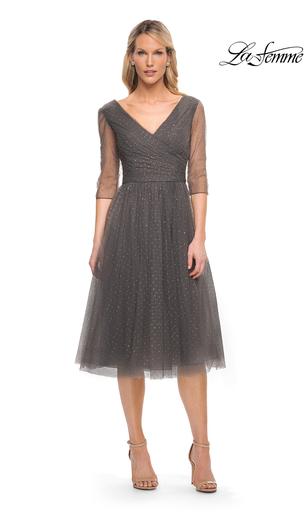 Woman wearing a gray dress with sheer sleeves on a white background, branded 'La Femme'.