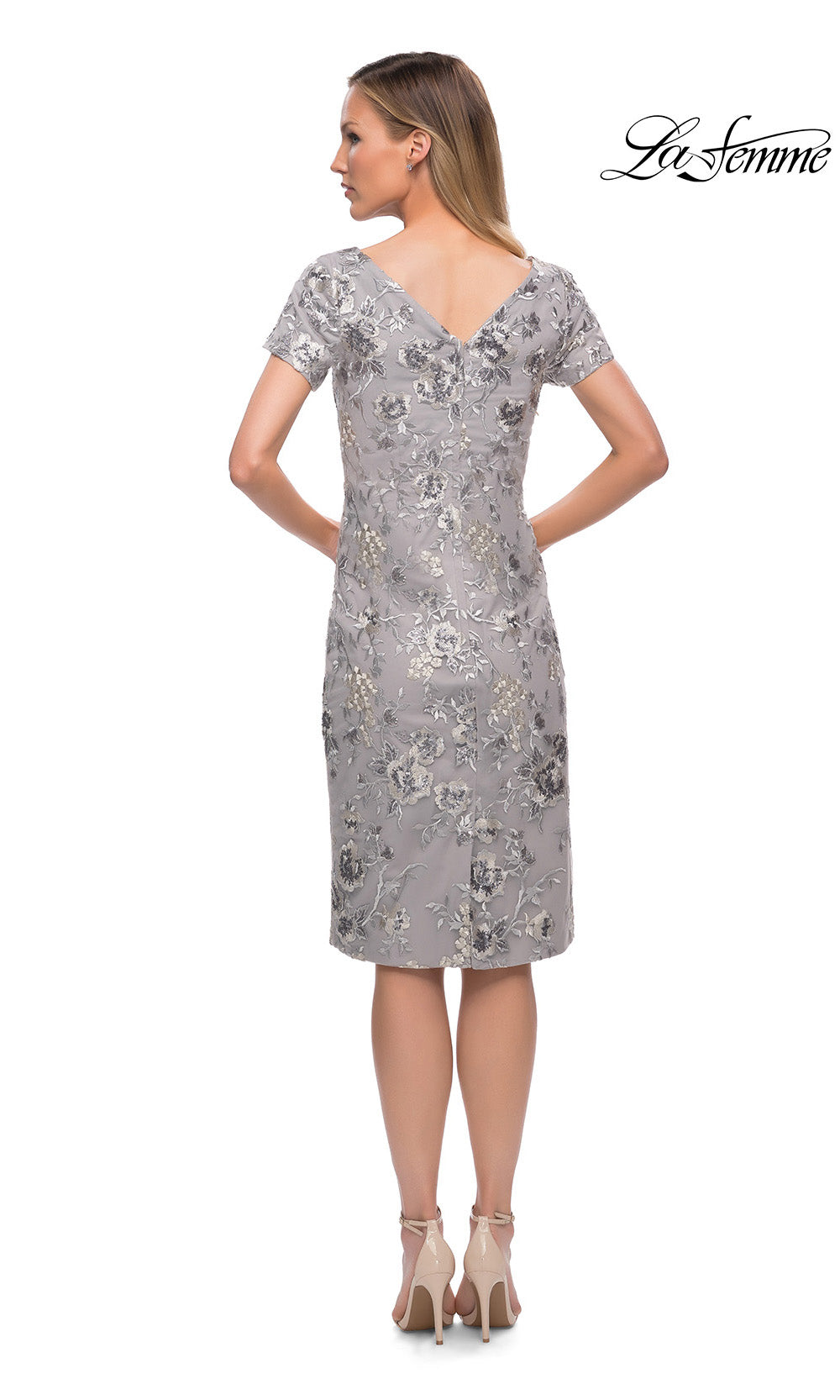 Woman wearing a silver sequin dress on a white background with 'La Femme' branding.
