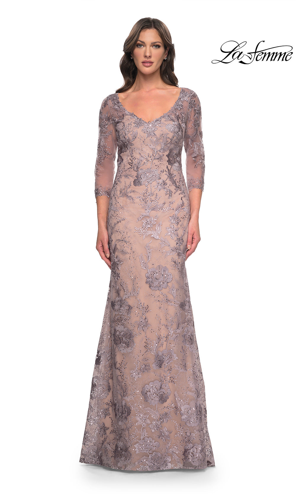 Woman wearing a lace evening gown with long sleeves on a white background, branded 'La Femme'.