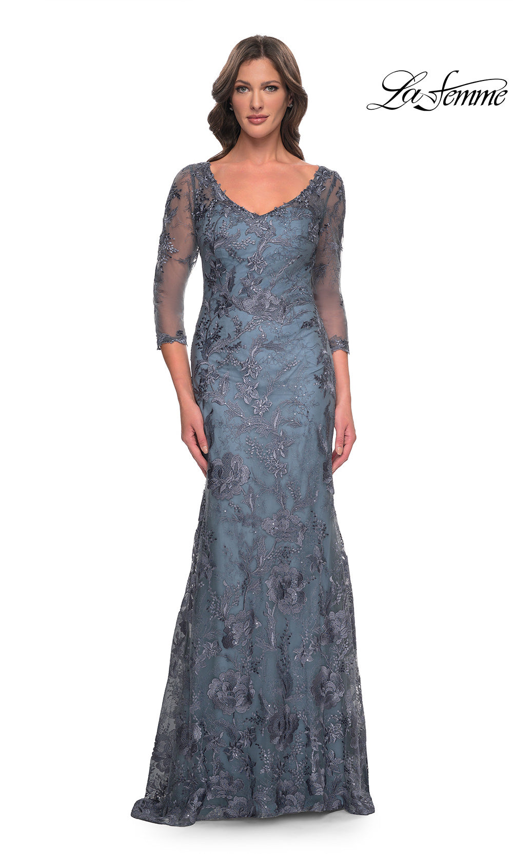 Woman wearing a blue lace evening gown with long sleeves on a white background, branded 'La Femme'.