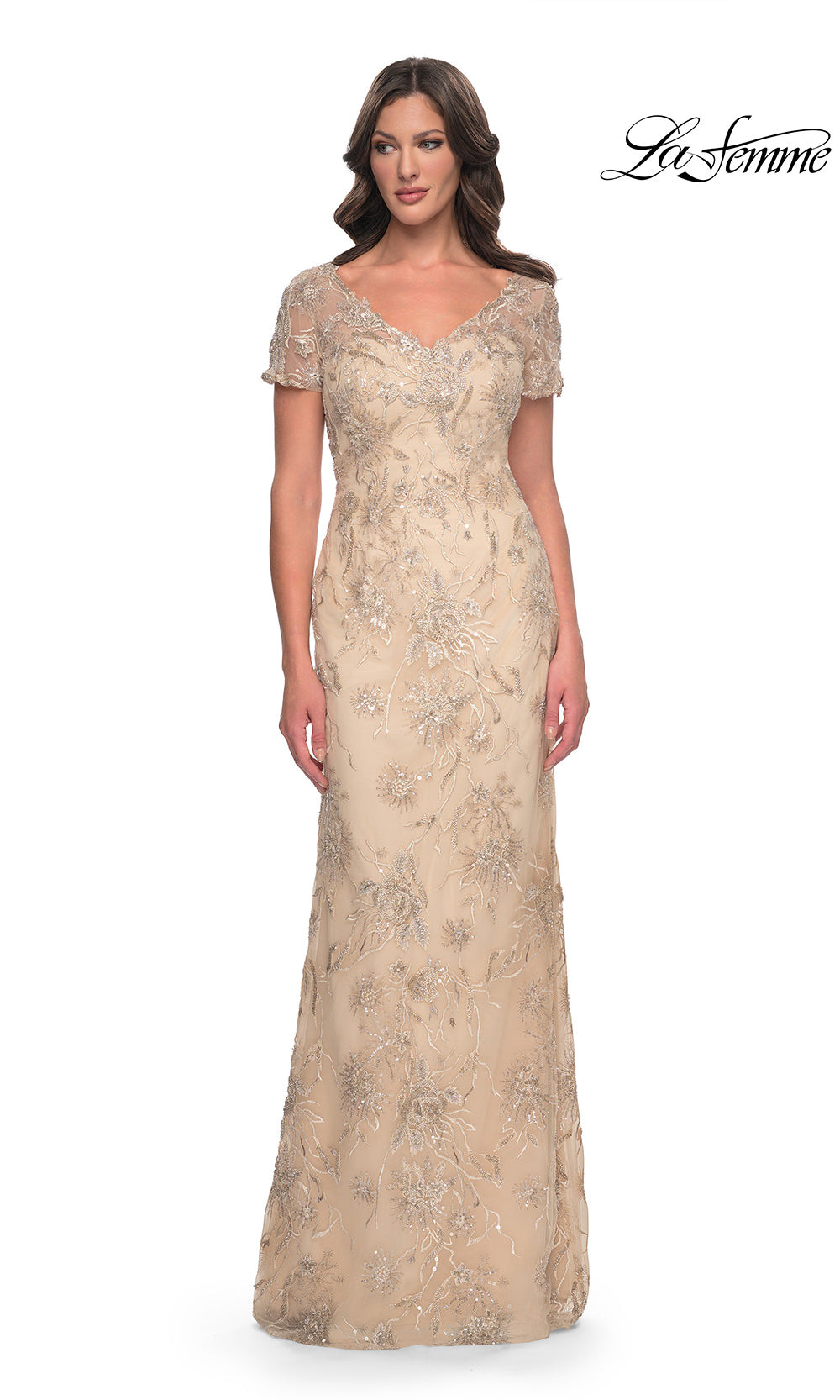 Woman wearing a beige floral evening gown on a white background