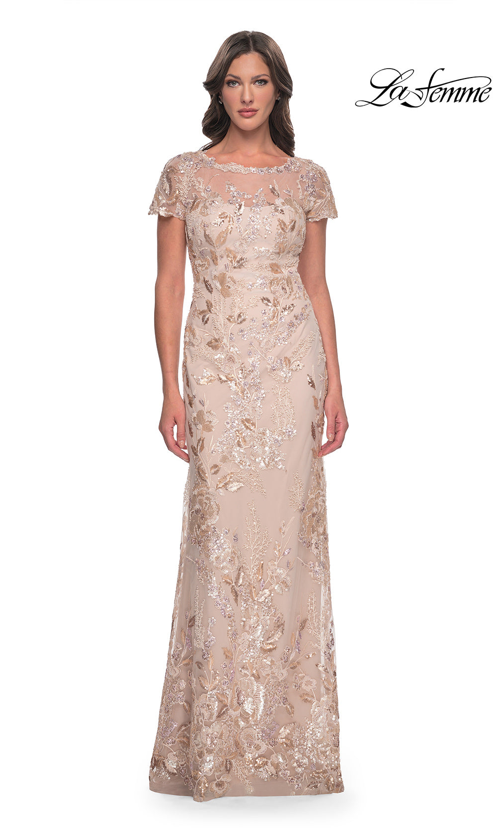 Woman wearing a beige evening gown with floral embellishments on a white background, branded 'La Femme'.