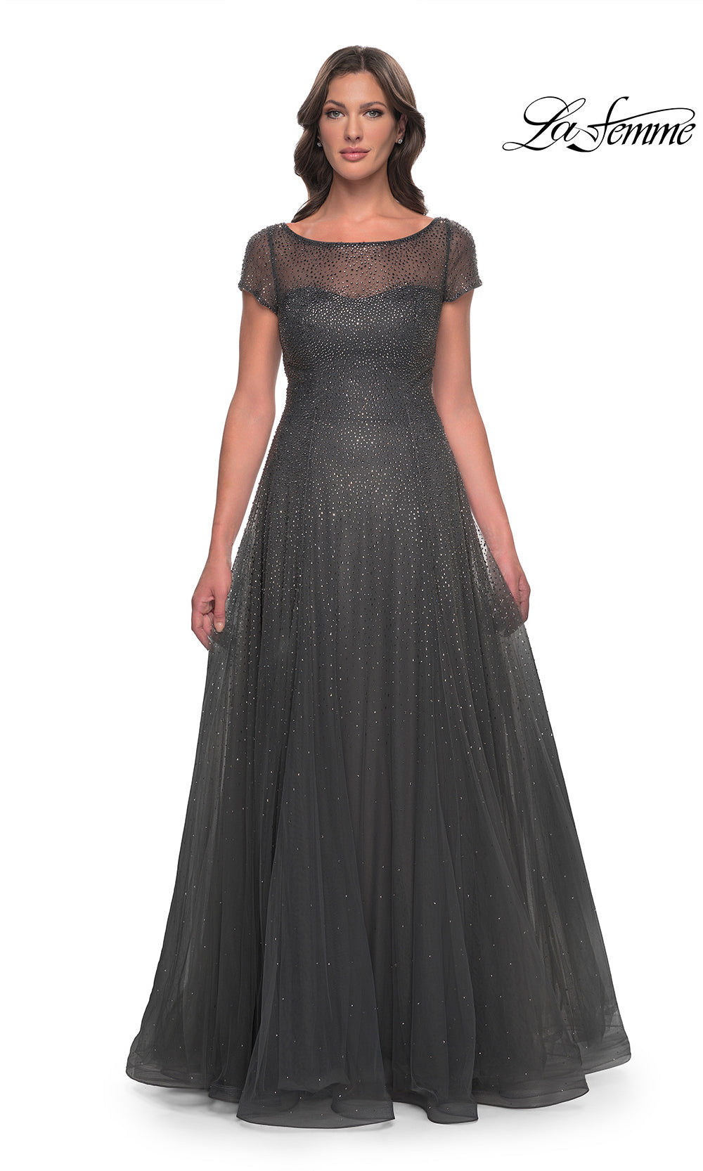 Woman wearing a black evening gown with sheer cap sleeves on a white background