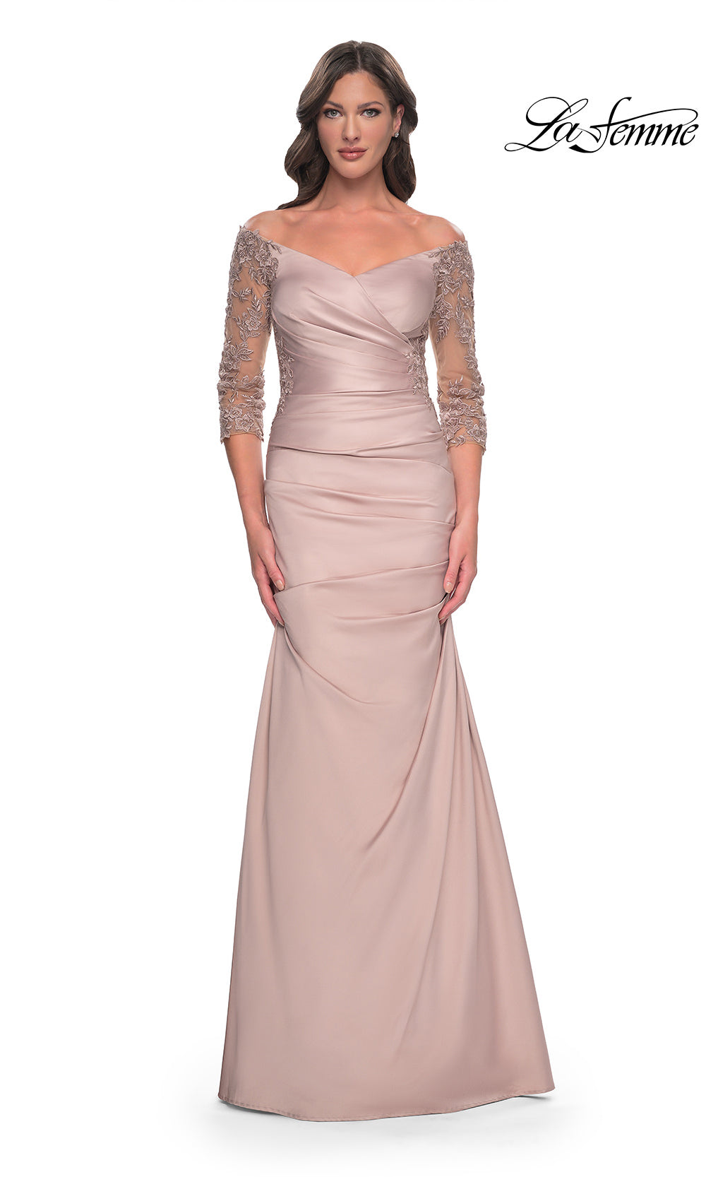 Woman wearing a long, elegant dress with lace sleeves on a white background