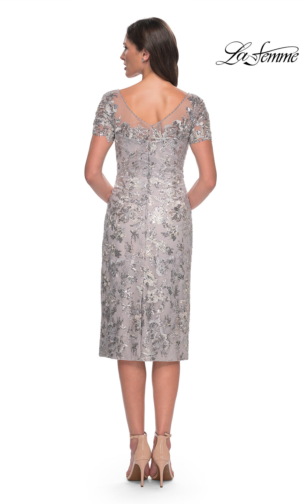 Woman wearing a silver sequin dress on a white background