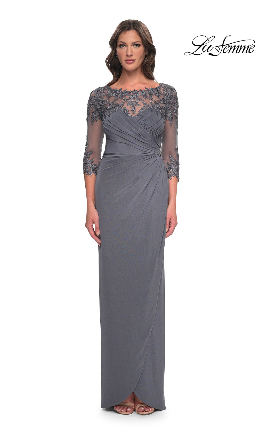 Woman wearing a gray evening gown with lace detailing on a white background