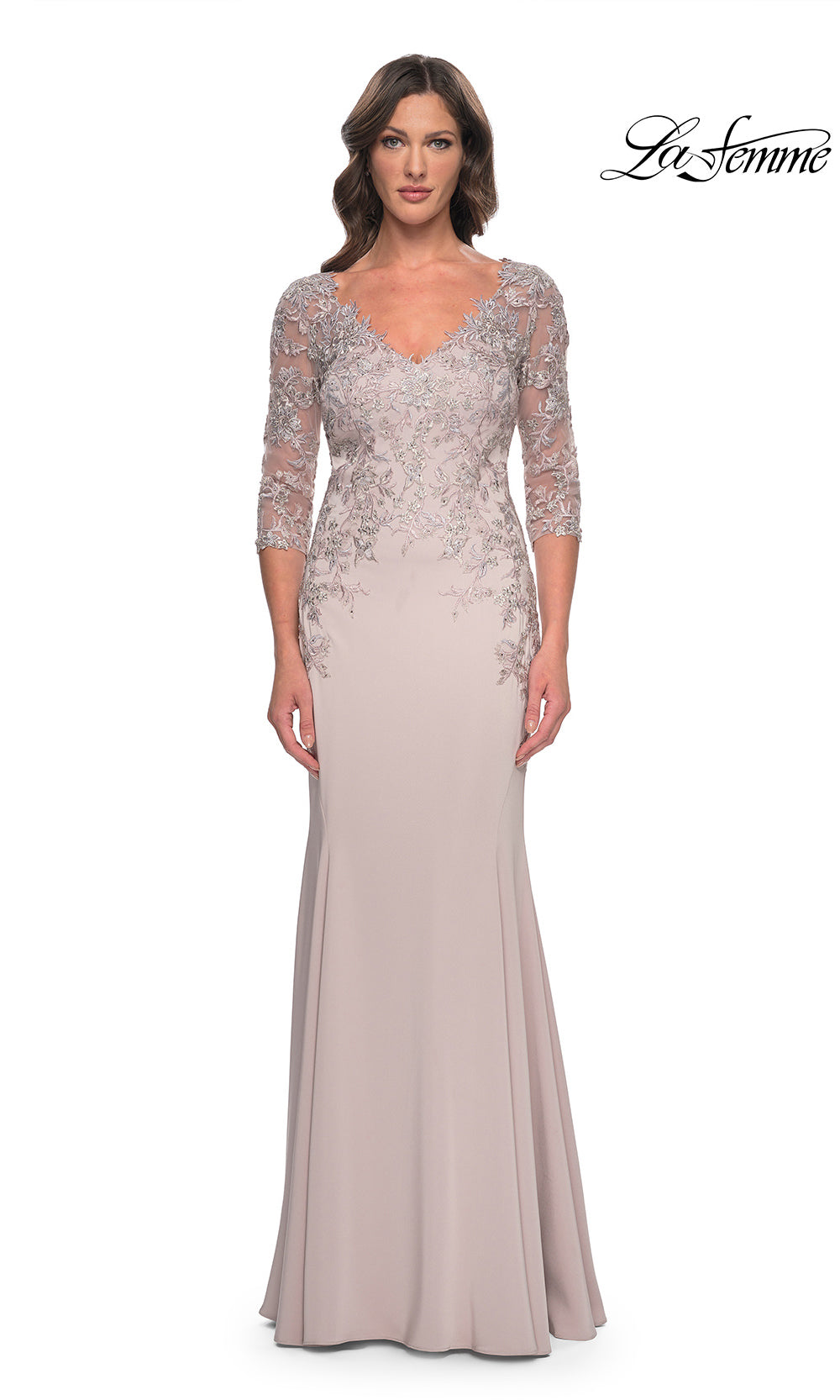 Woman wearing a lace evening gown with a plain background