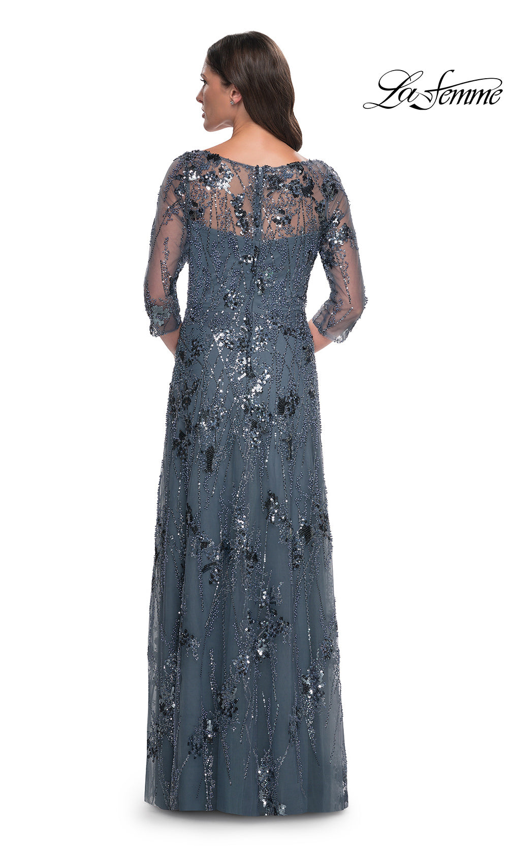 Long, dark blue evening gown with lace detailing on a white background