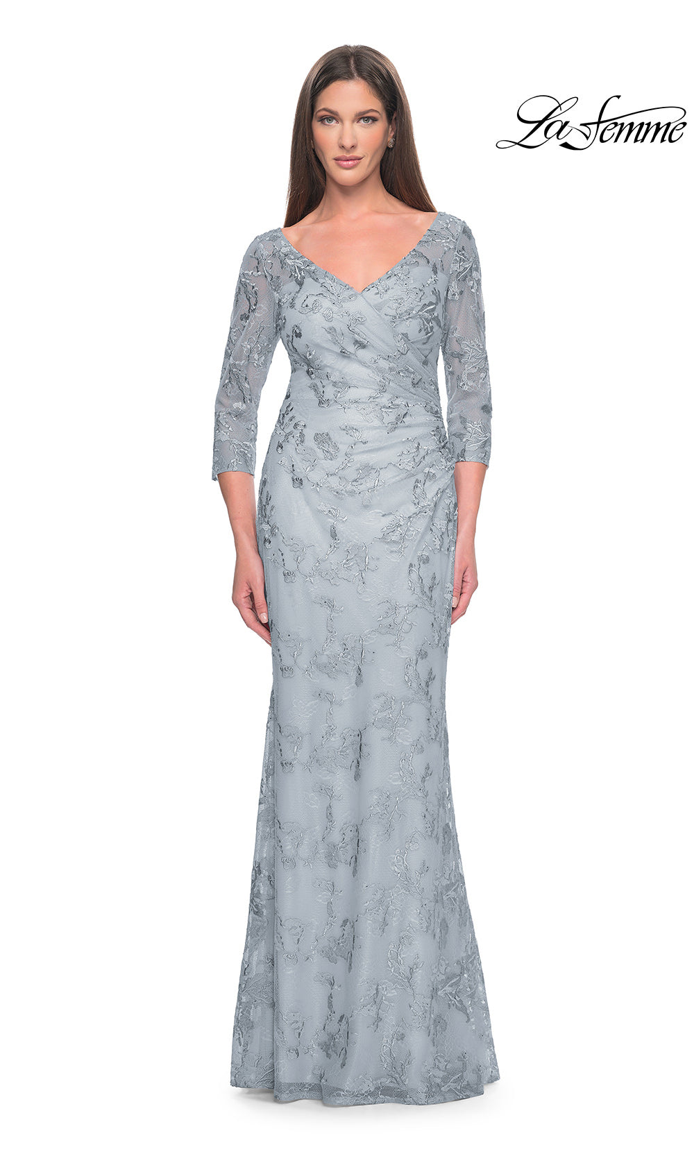 Woman wearing a gray lace evening gown on a white background
