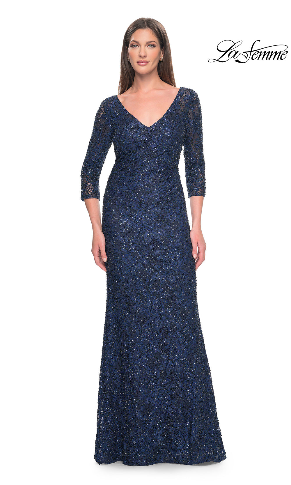 Woman wearing a navy blue sequin evening gown on a white background