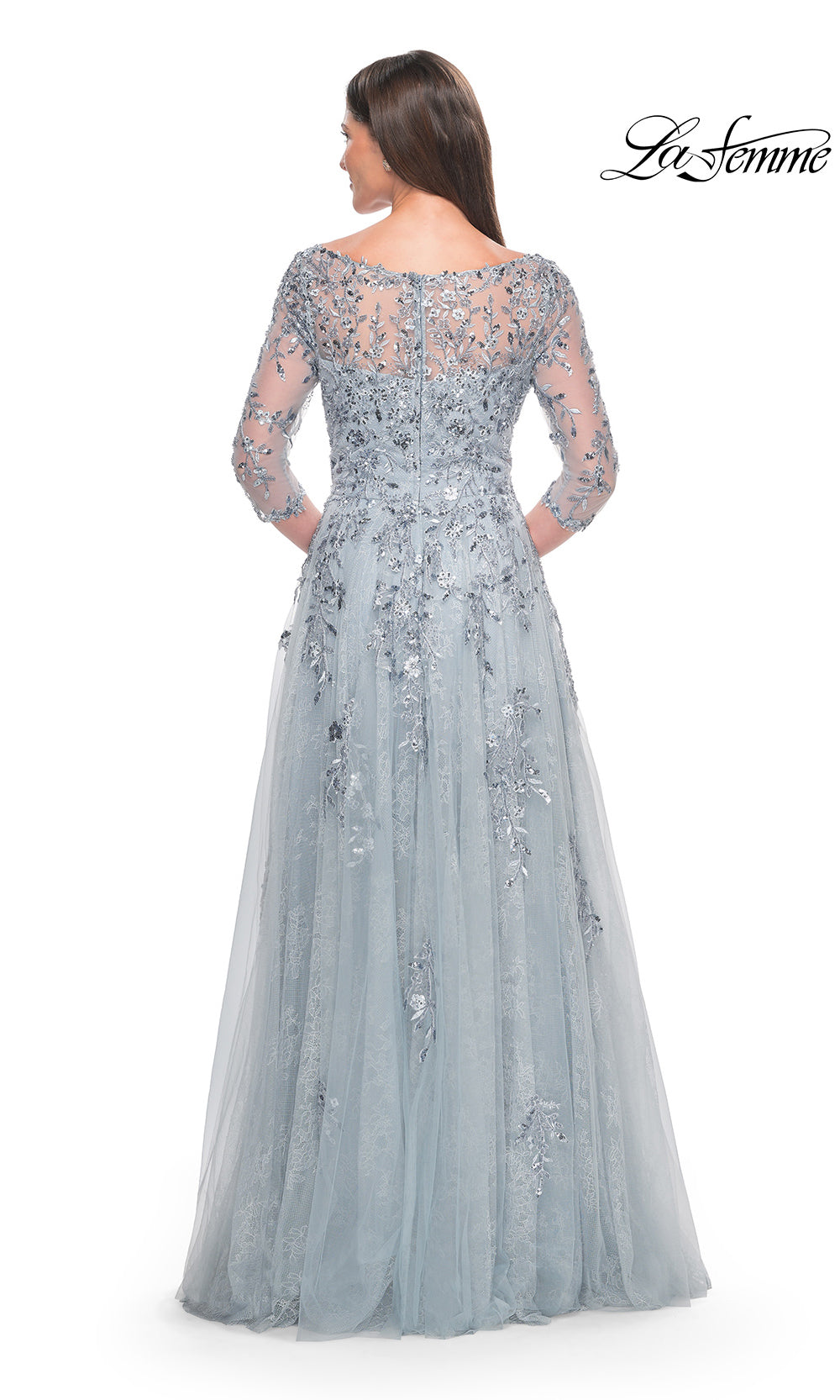 Long, elegant silver dress with lace detailing on a white background