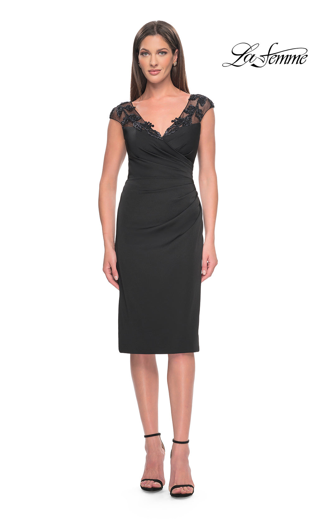 Woman wearing a black dress with lace sleeves on a white background, branded 'La Femme'.