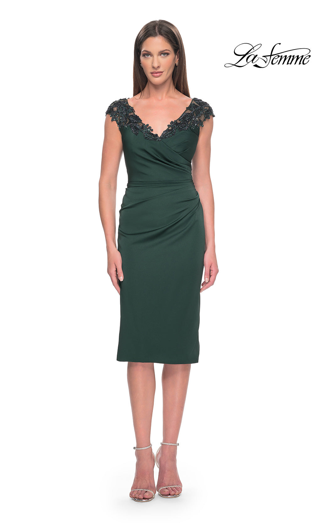 Green dress with embellished neckline on a white background