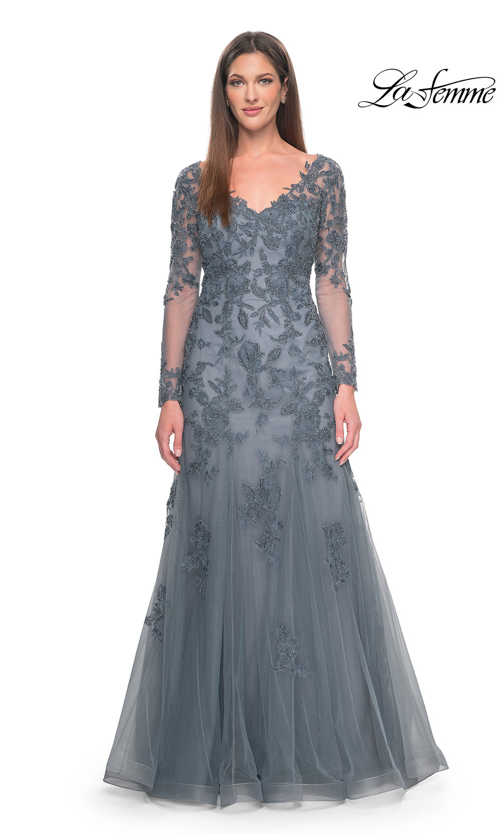 Woman wearing a gray lace evening gown on a white background