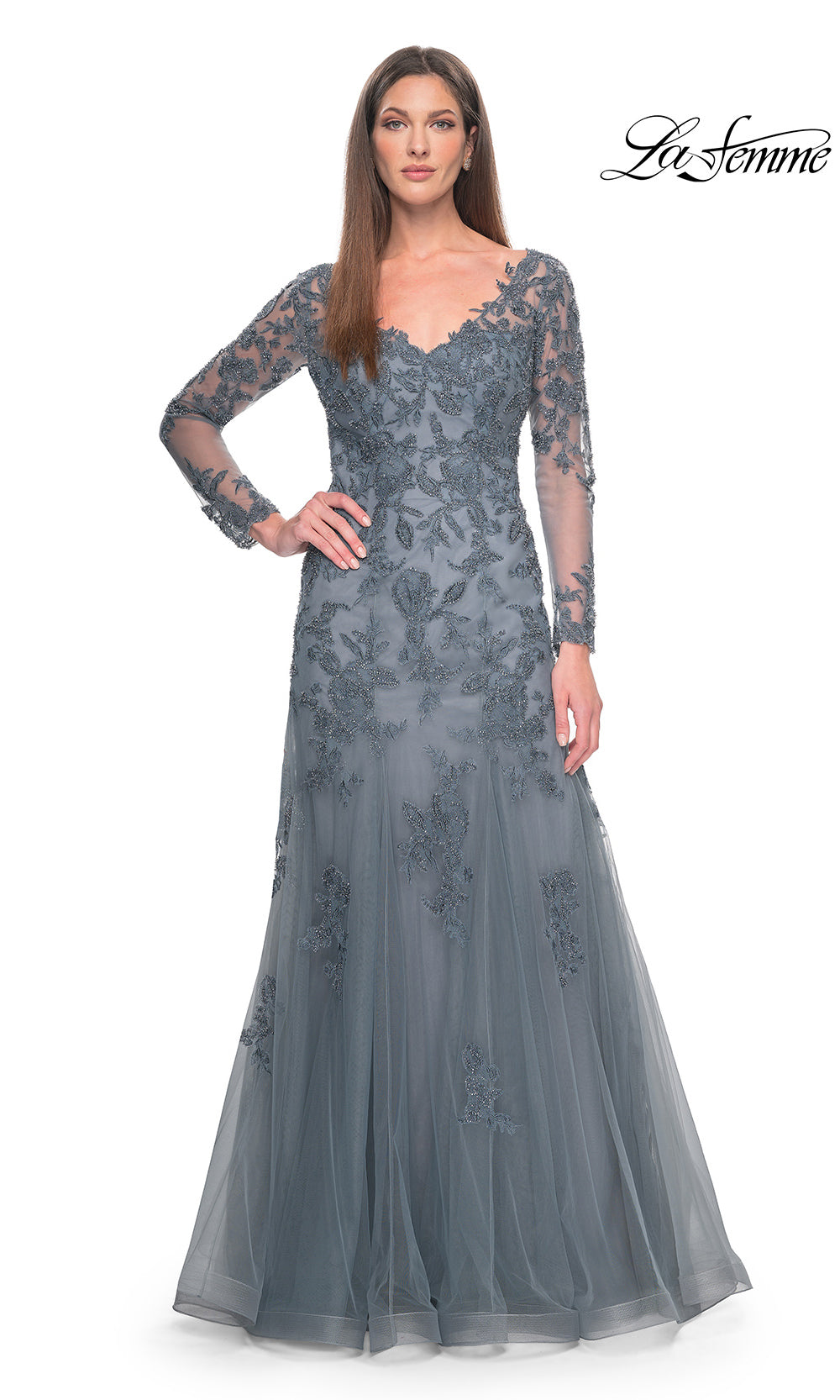 Woman wearing a gray lace evening gown on a white background