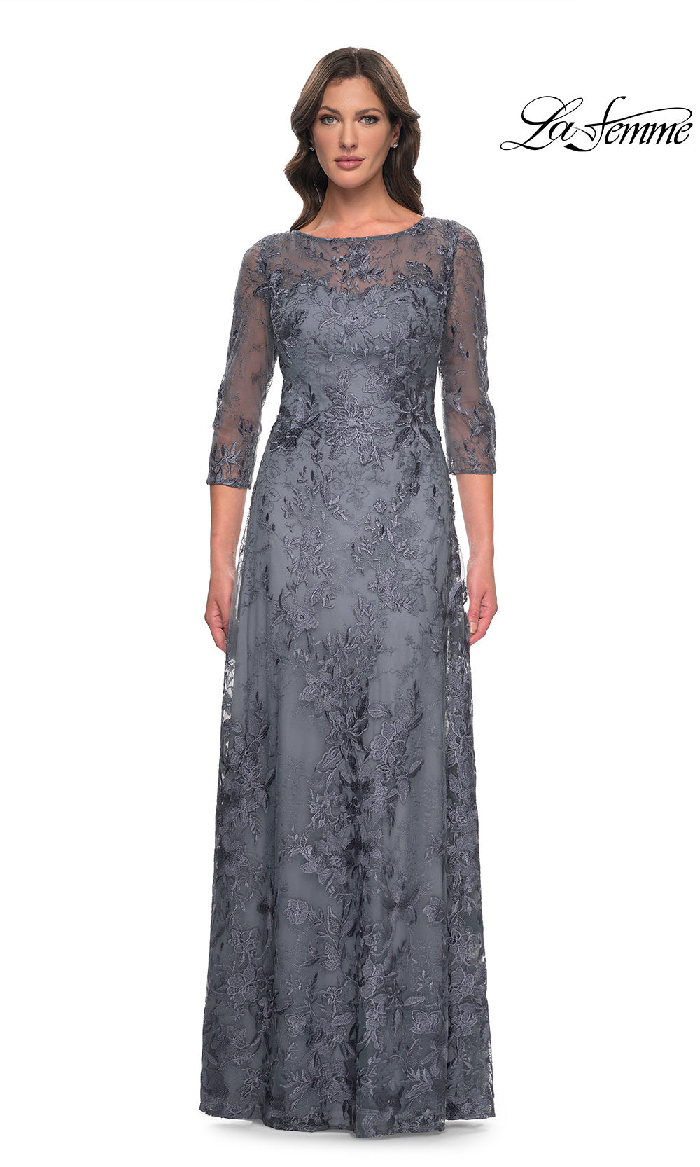 Woman wearing a gray lace evening gown on a white background with 'La Femme' branding.