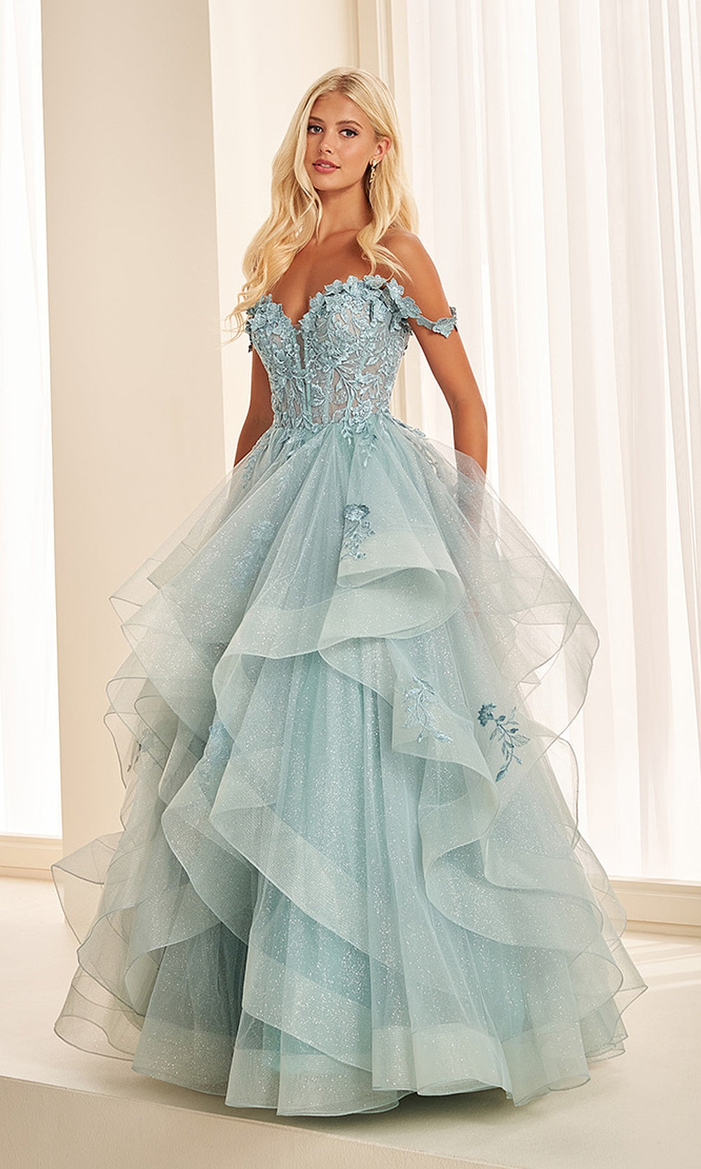 Ellie Wilde EW35084 Sage prom dress front view with glitter tulle, floral appliques and corset bodice, off-shoulder sweetheart ballgown silhouette, a gorgeous pageant-ready gown.