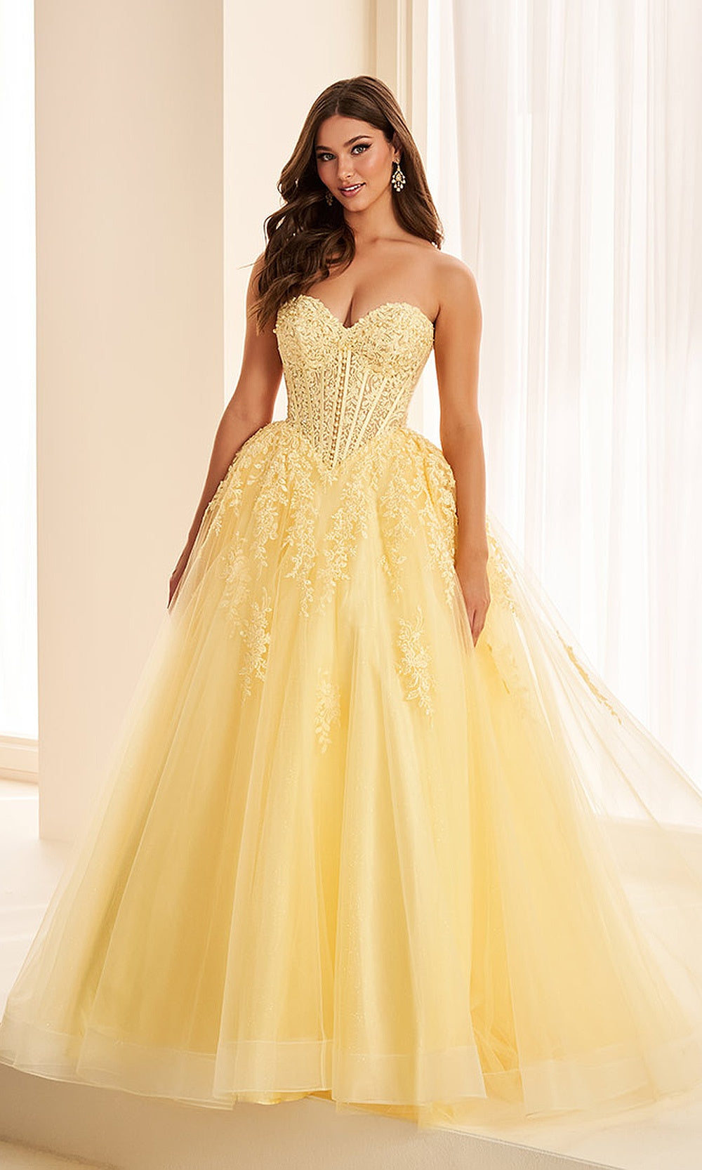 Ellie Wilde EW38018 Light Yellow prom dress front view with beaded lace tulle ballgown silhouette, sweetheart neckline, corset back, and floral appliques for a formal prom gown.