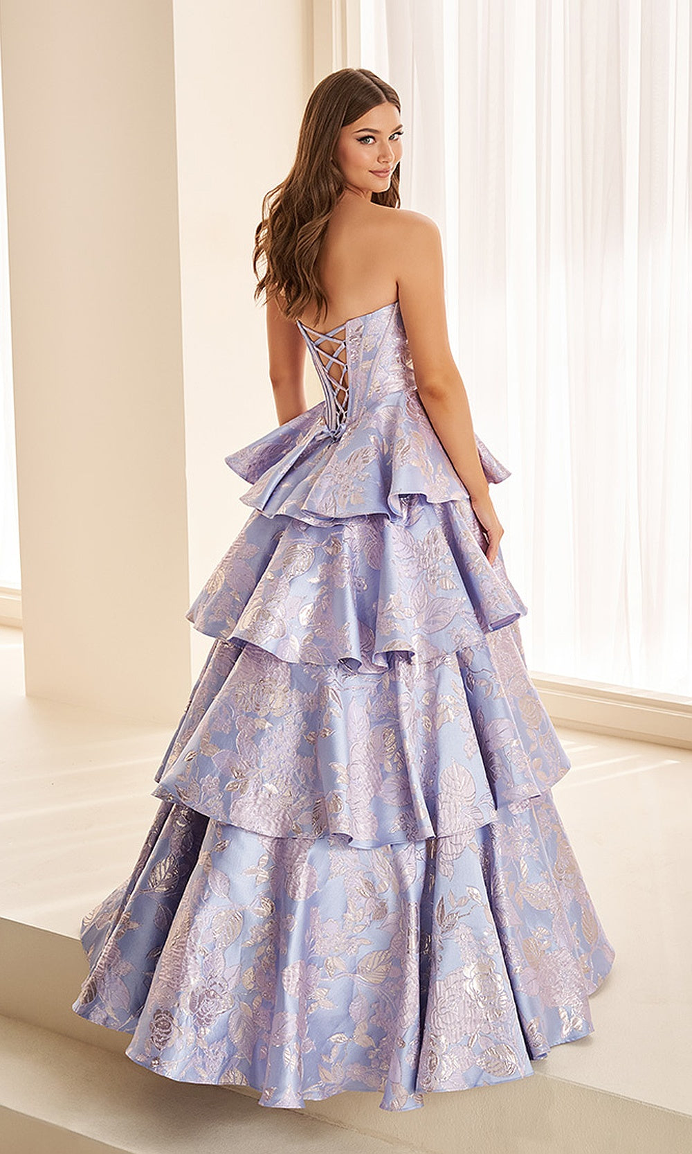 Ellie Wilde EW38045 Lavender Blue prom dress back view with metallic jacquard fabric, corset back closure, ballgown silhouette, elegant evening gown with tiered ruffle skirt.