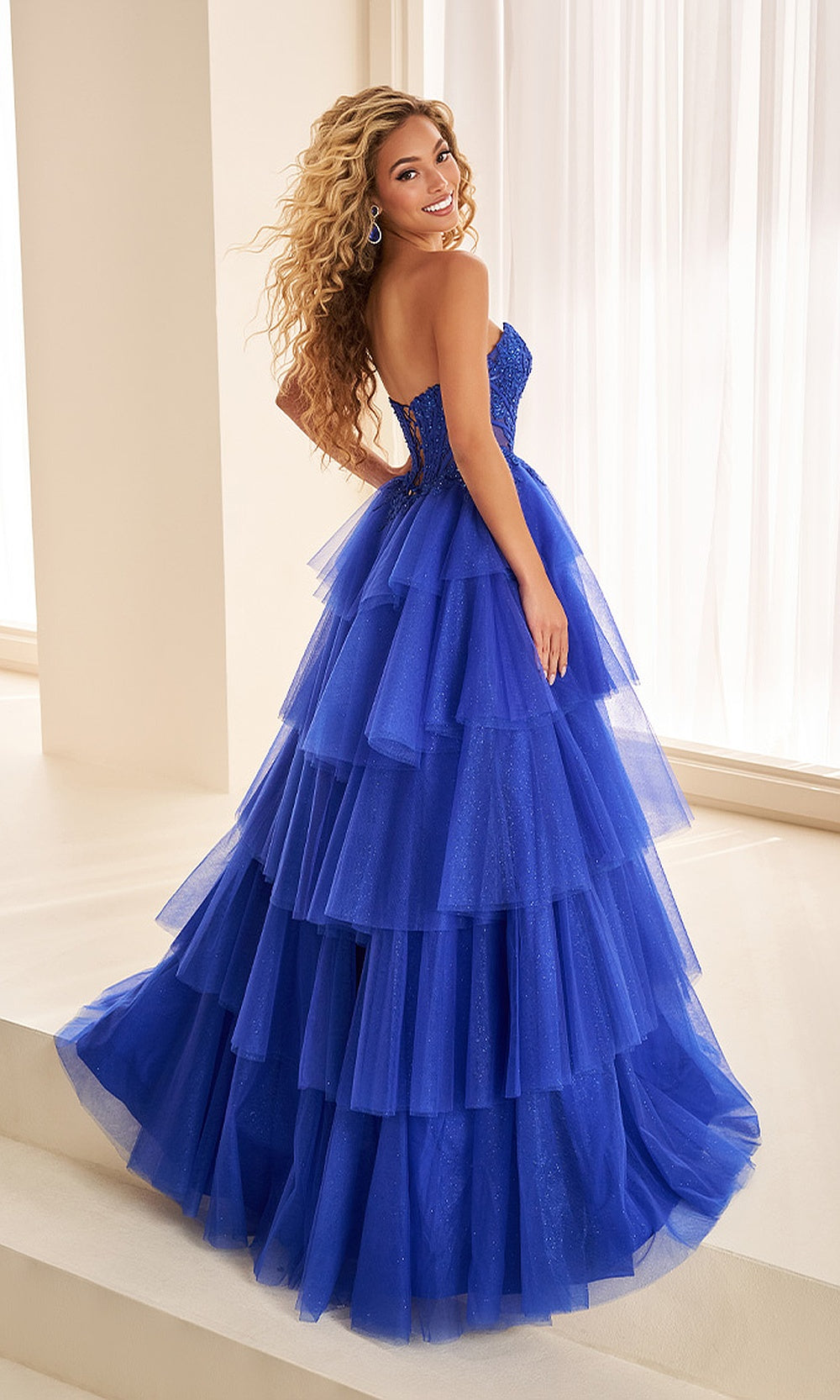 Ellie Wilde EW38074 Royal Blue prom dress back view crisscross lace-up corset back sweep train tiered glitter tulle ballgown evening gown