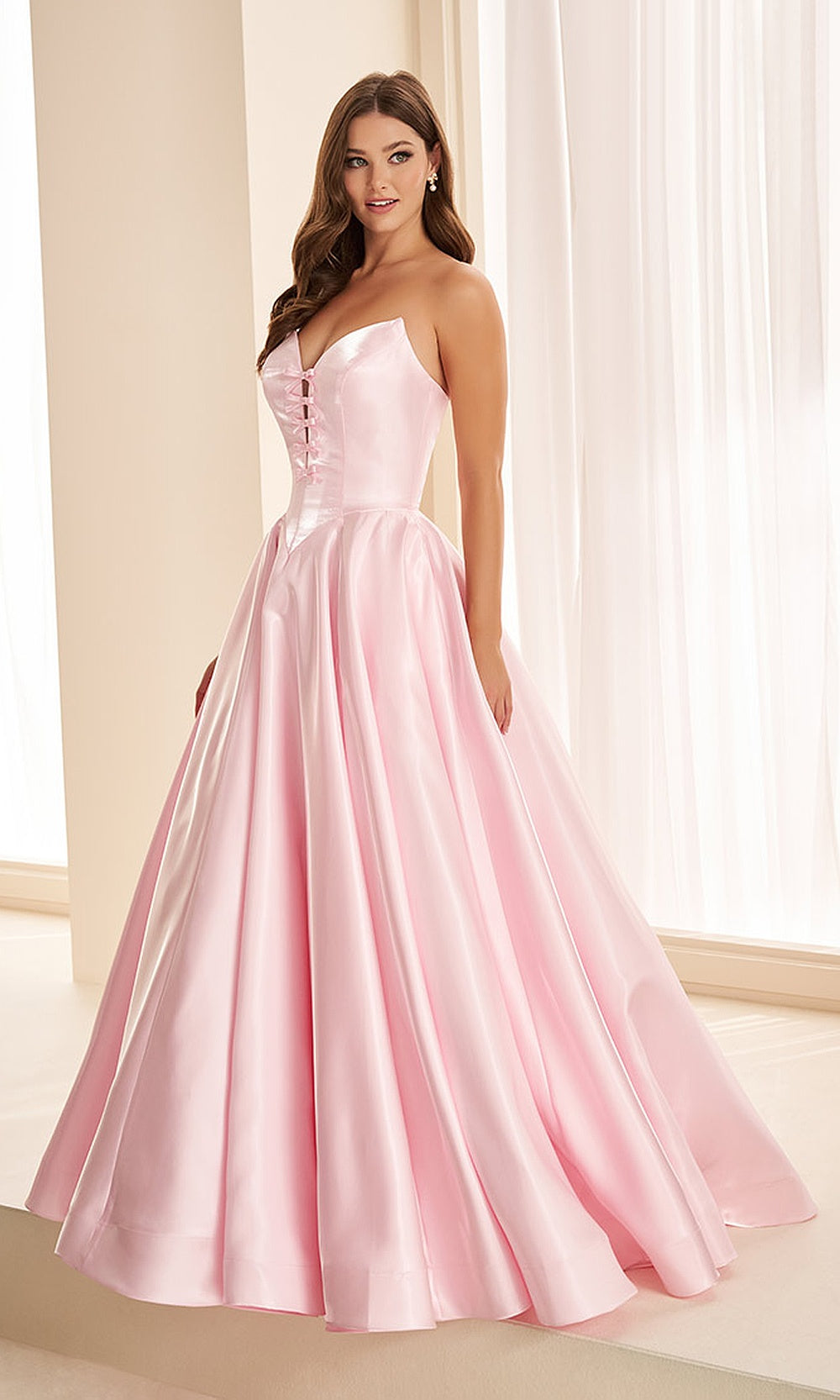 Ellie Wilde EW38078 Sakura Pink strapless sweetheart satin ballgown front view with boned corset bodice, bow keyhole detail, full A-line skirt, formal prom gown