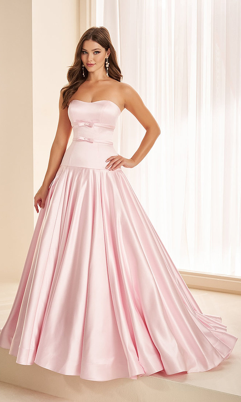 Ellie Wilde EW38080 Sakura Pink prom dress with smooth satin, drop-waist bow belt, strapless A-line ballgown silhouette, front view, formal prom gown