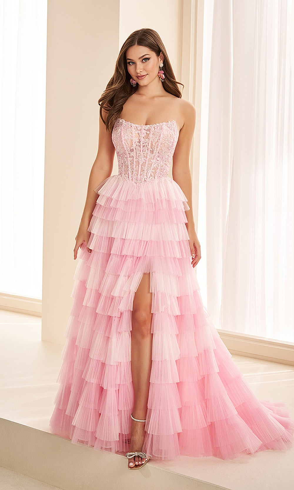 Ellie Wilde EW38126 Light Pink strapless lace corset prom dress front view with tulle, floral appliques, boning, A-line silhouette, formal prom gown.