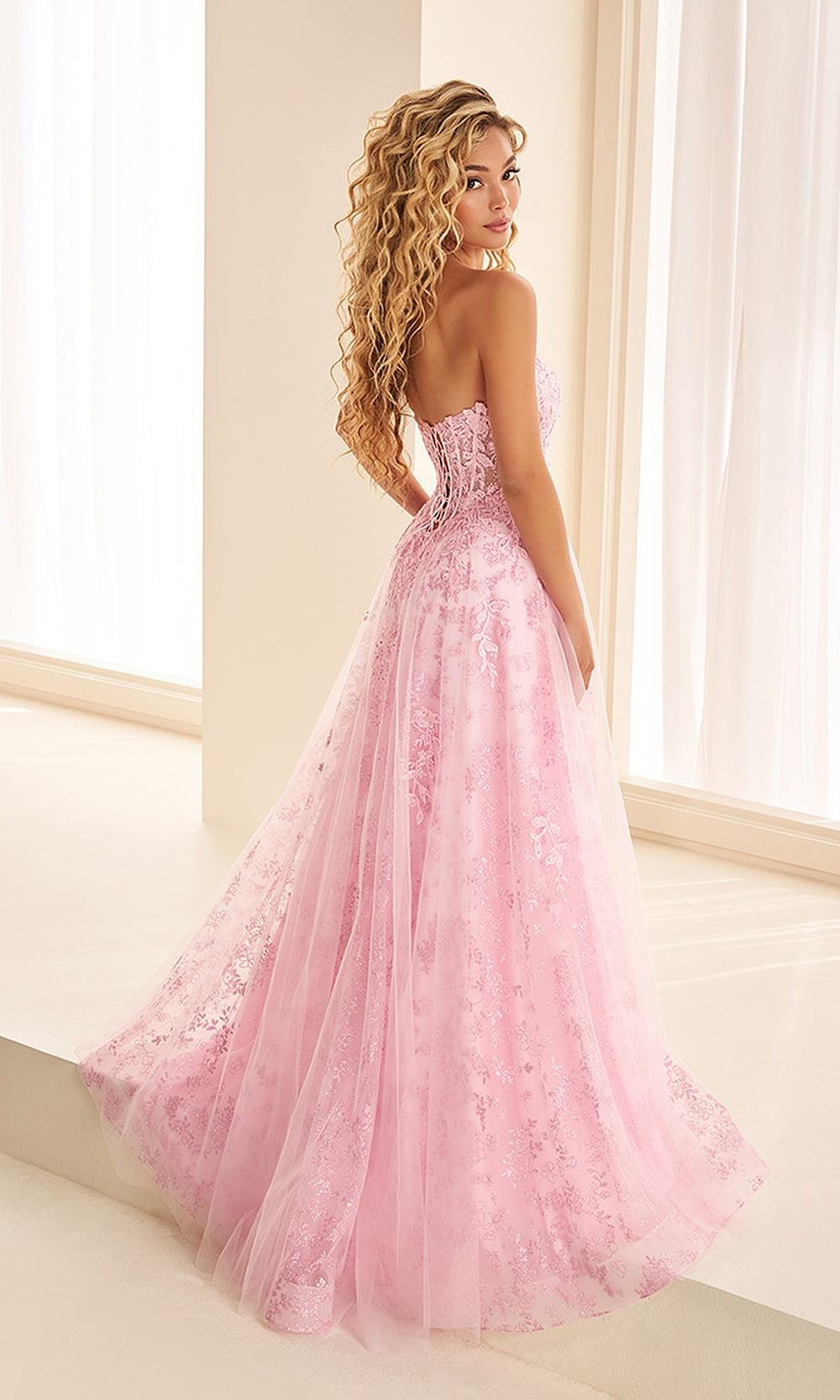 Ellie Wilde EW38131 Light Pink prom dress back view with tulle and lace, illusion corset back, a-line ballgown silhouette, pageant-ready gown.