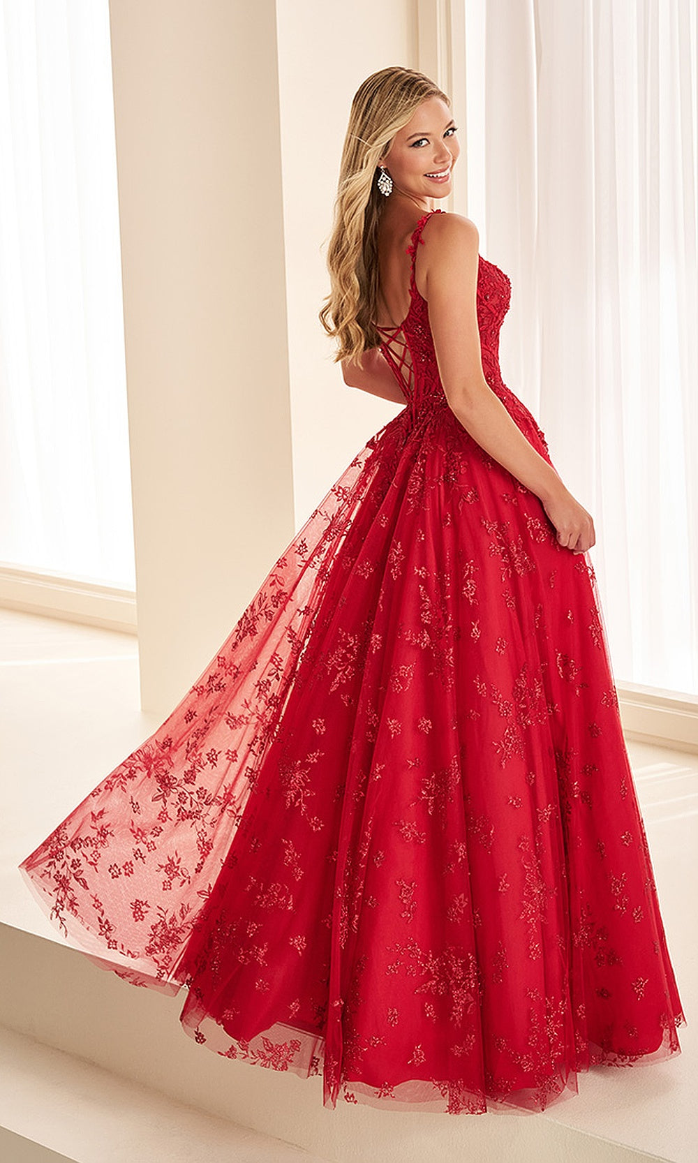 Ellie Wilde EW38136 Dark Red prom dress back view with lace corset back, boning, straps, and a flowing glitter tulle ballgown skirt, an elegant evening gown.