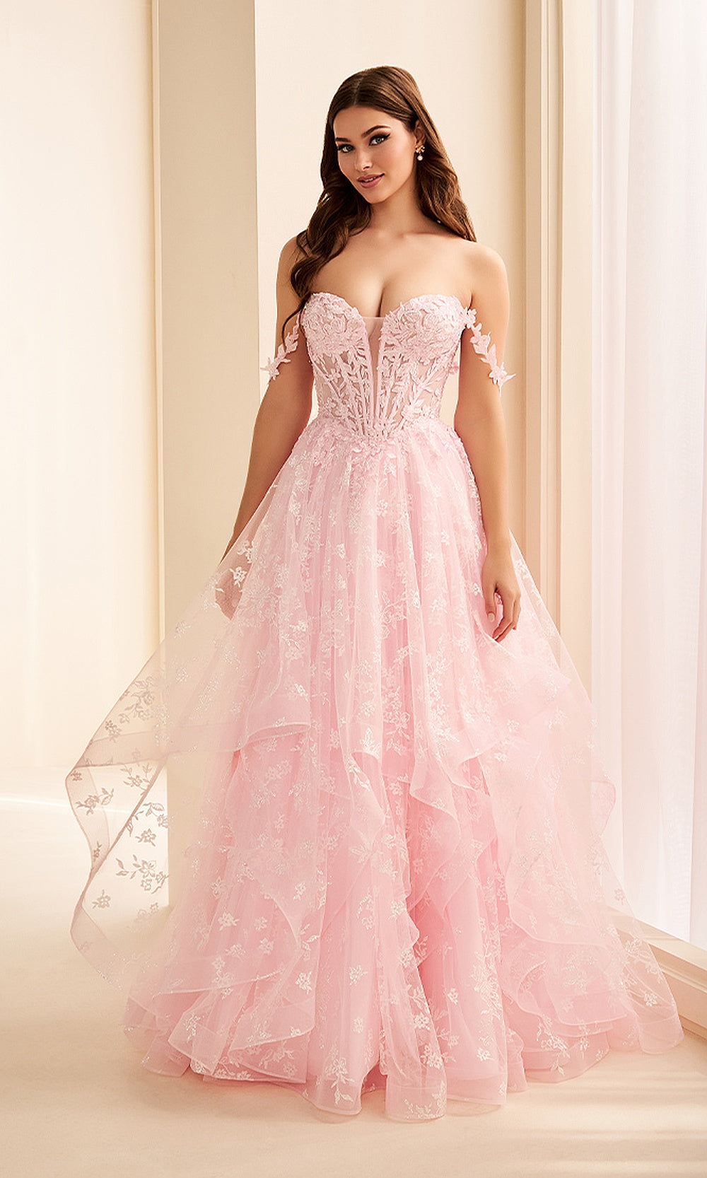 Ellie Wilde EW38204 Light Pink prom dress front view with glitter tulle, floral lace appliques, sweetheart corset bodice, and voluminous ruffle ballgown skirt, formal prom gown.