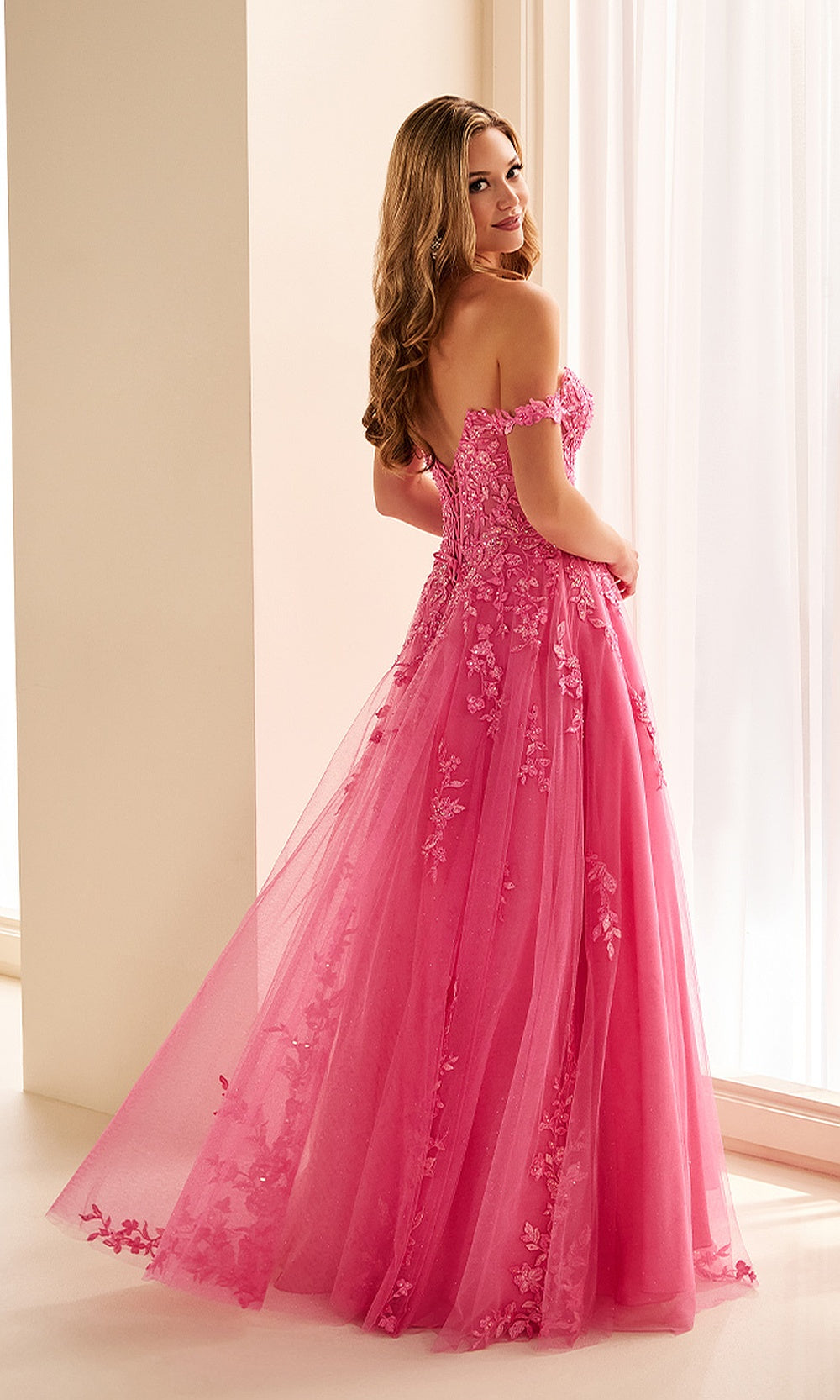 Ellie Wilde EW38205 Hot Pink prom dress back view with lace and sequin fabric, corset back closure, off-shoulder ballgown silhouette, evening gown.