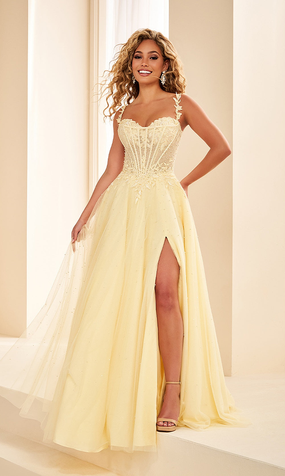 Ellie Wilde EW38210 Light Yellow prom dress front view with glitter tulle and lace, floral appliques and beading, off-shoulder sweetheart ballgown silhouette, gala gown.