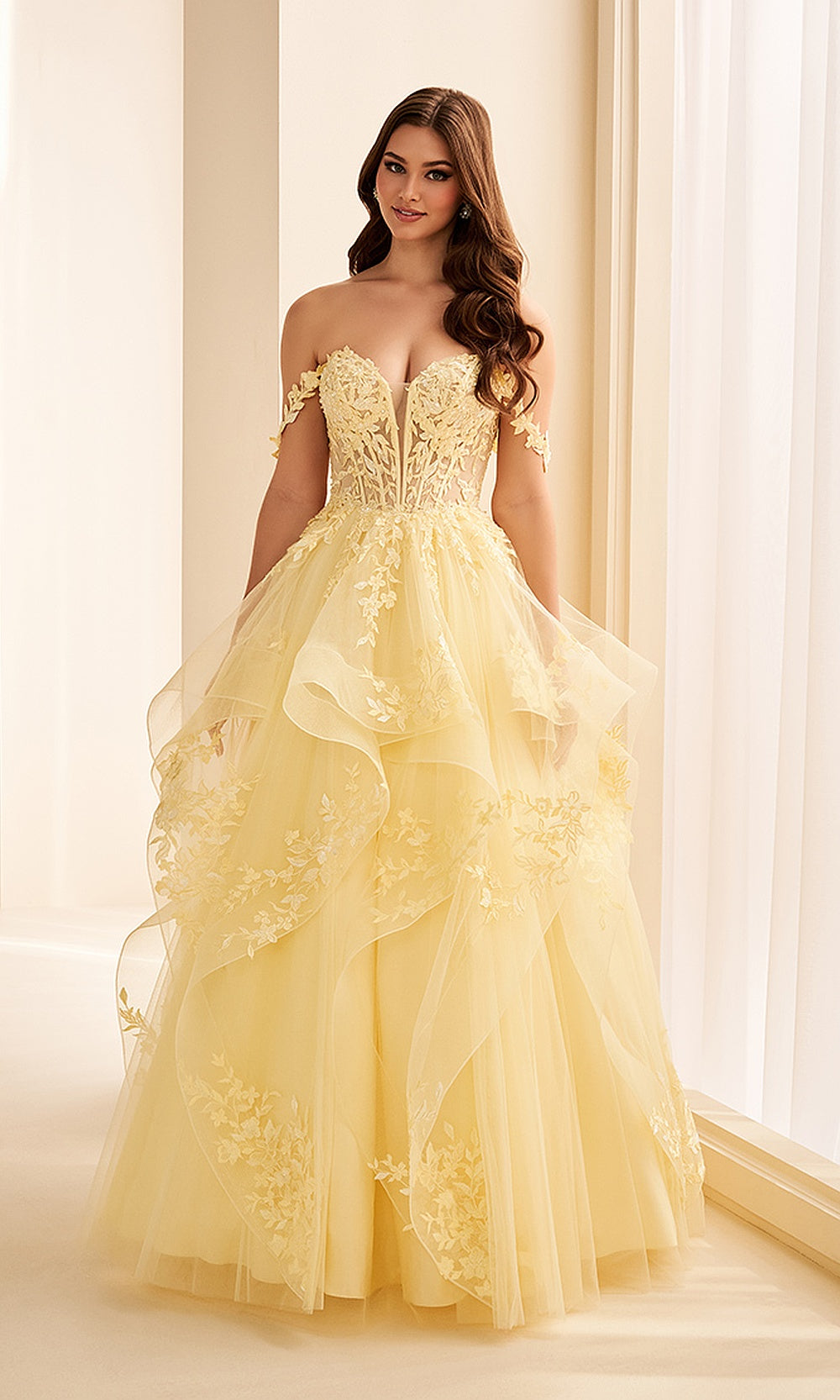 Ellie Wilde EW38211 Light Yellow prom dress front view with glitter tulle, floral appliques, sweetheart corset bodice, ruffled ballgown skirt, formal prom gown.
