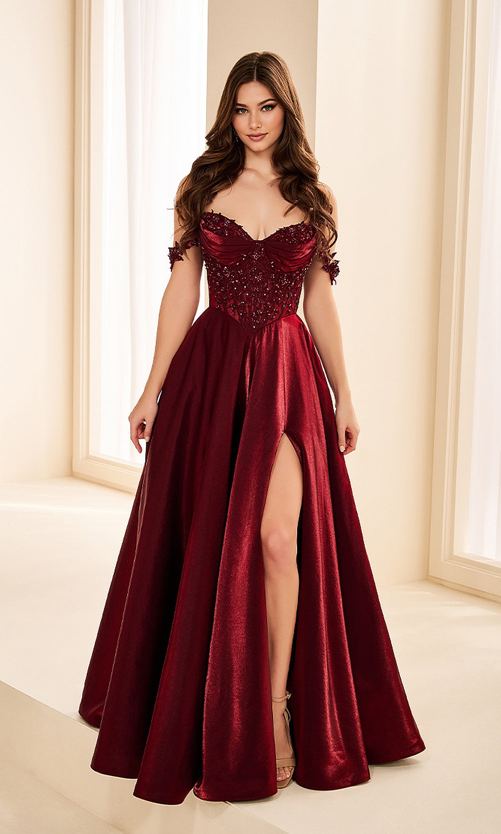Ellie Wilde EW38218 Merlot off-shoulder beaded lace prom dress front view with satin, floral appliques, a-line ballgown silhouette, formal prom gown.