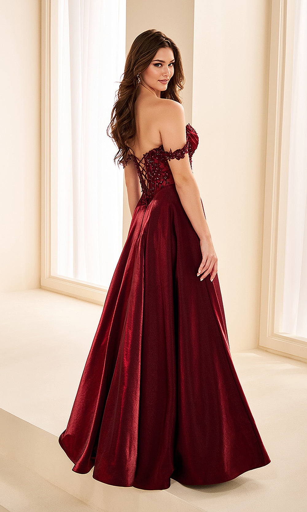 Ellie Wilde EW38218 Merlot off-shoulder beaded lace prom dress back view with satin, corset back, a-line ballgown silhouette, pageant-ready gown.