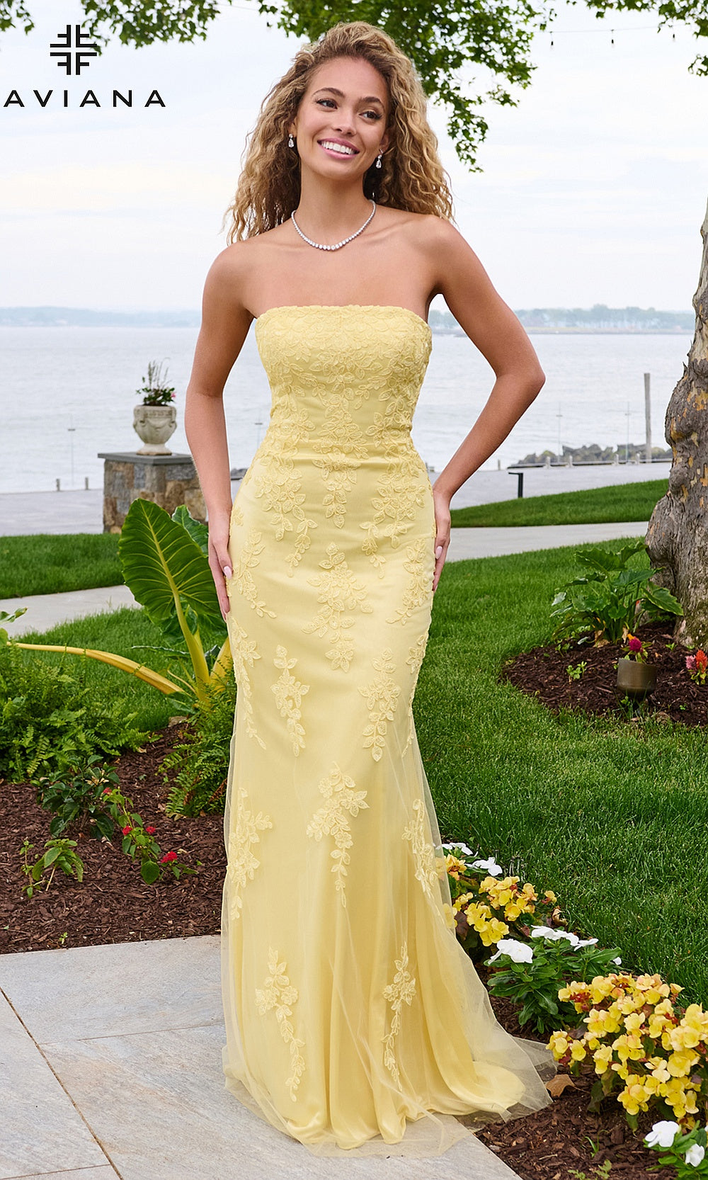 Faviana 11627 Light Yellow strapless mermaid gown front view with tulle base, floral lace appliqués, boned bodice, sweep train, prom gown