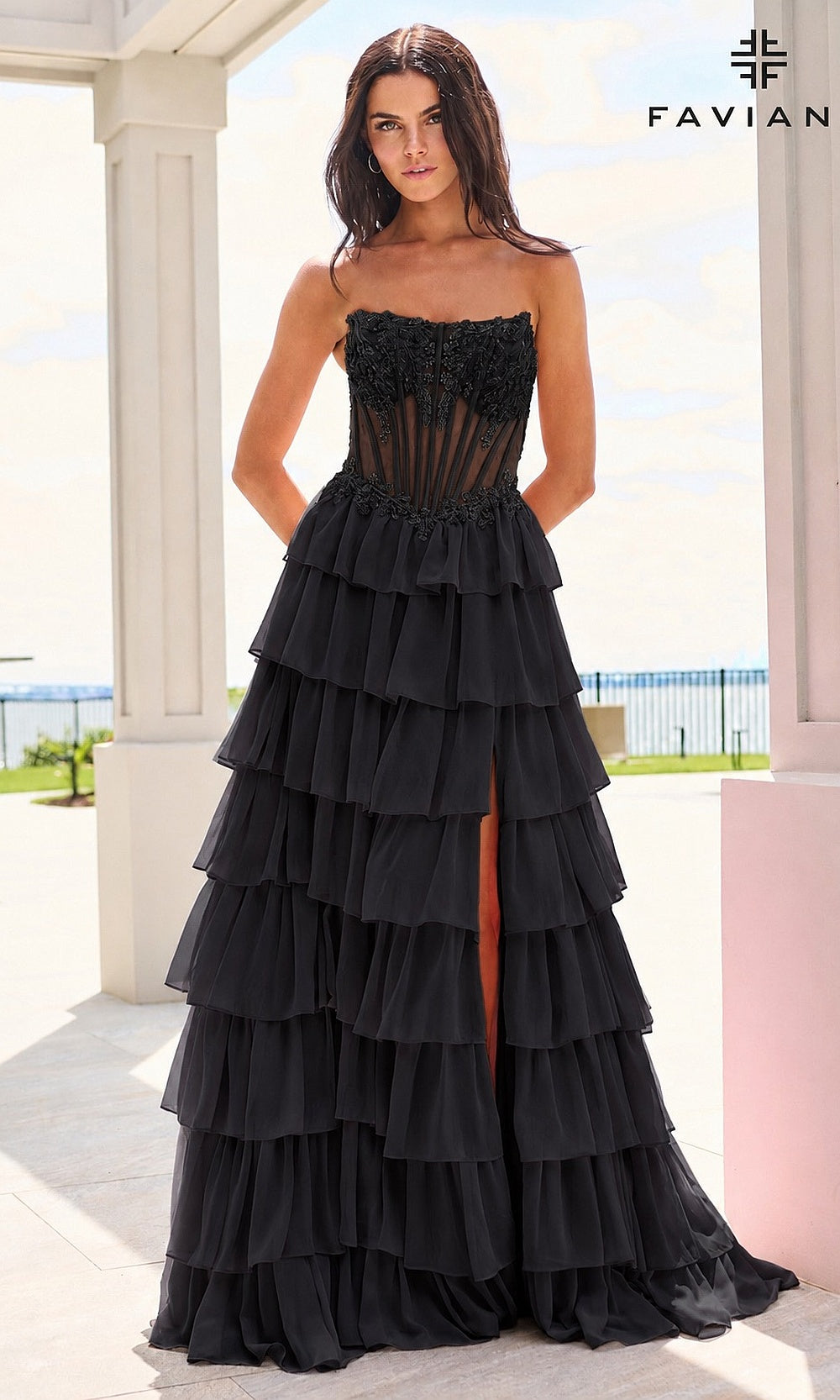 Faviana 11629 Black prom dress front view with strapless scoop neckline, sheer boned corset bodice, lace floral appliqués at neckline, tiered chiffon ruffle skirt, evening gown