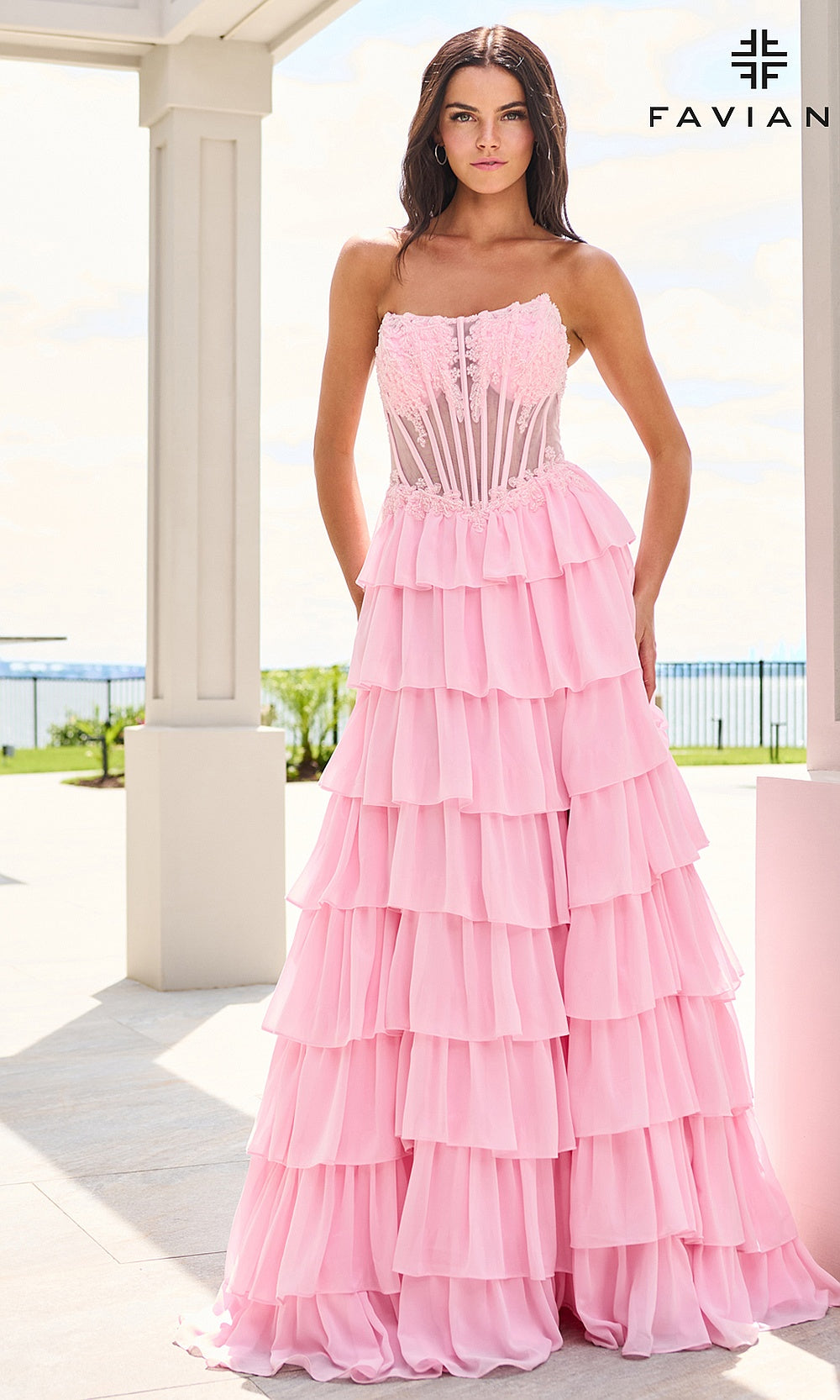 Faviana 11629 Light Pink prom dress on-model front view with strapless scoop neckline, sheer boned corset bodice, lace floral appliqués at neckline, tiered chiffon ruffle skirt, evening gown