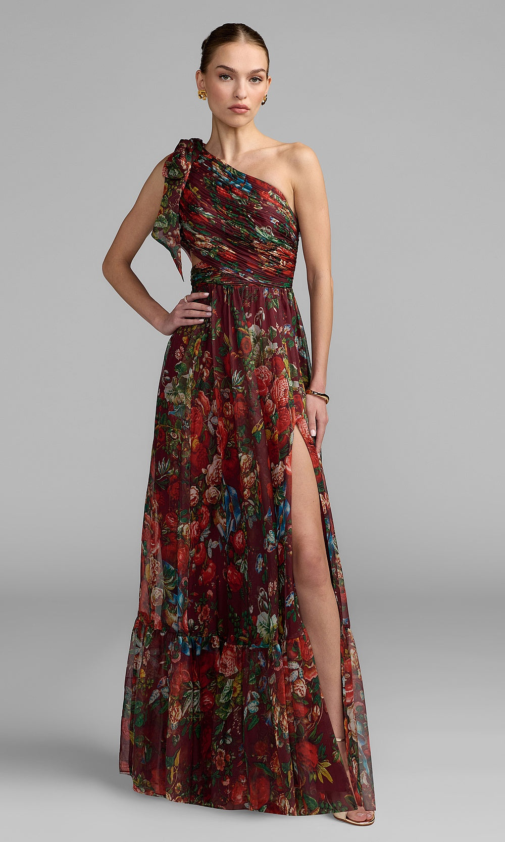 Mac Duggal 68553 Wine Red Multicolor front view one-shoulder floral chiffon a-line prom gown with bow strap, waist cut-out, tiered ruffle hem, and high slit, formal prom gown