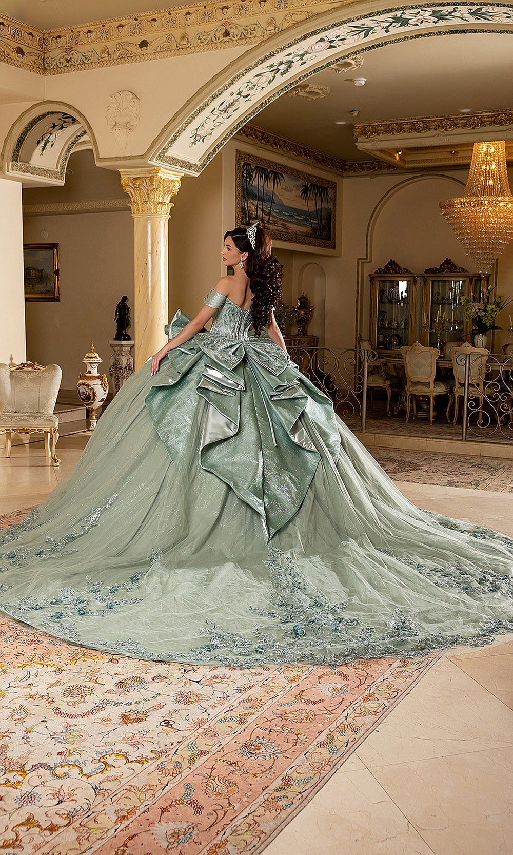 May Queen LK297 sage green quinceañera ball gown — back view of the bow and sweeping glitter train