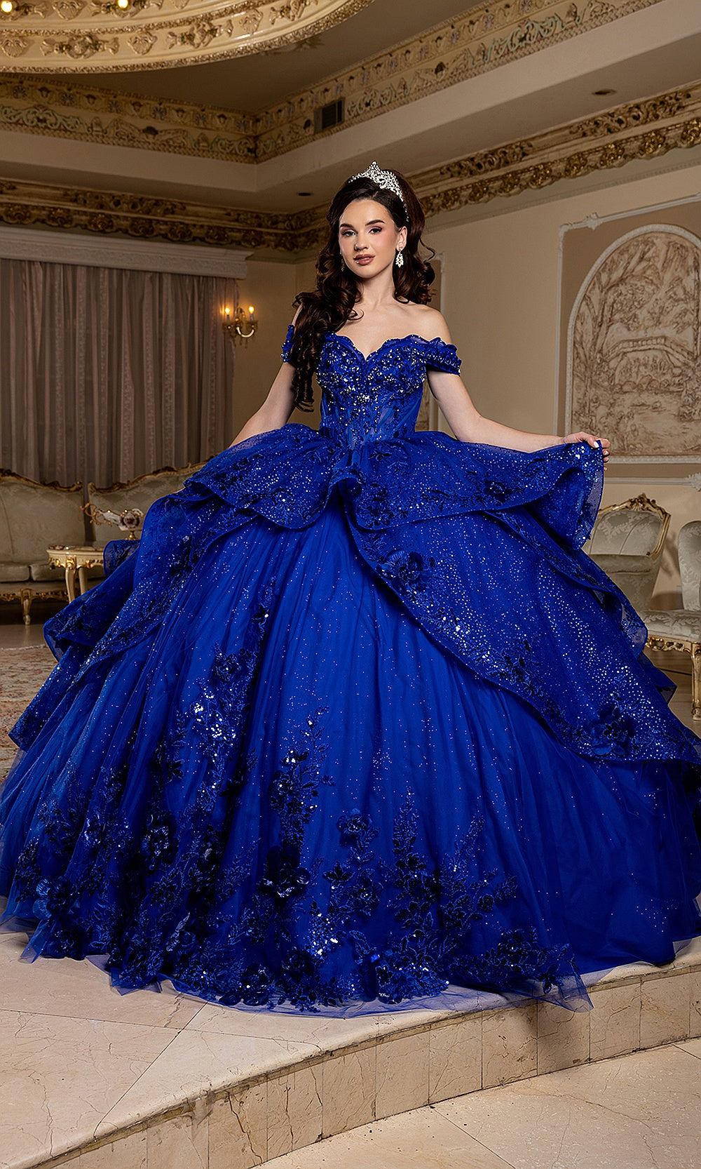 May Queen LK298 royal blue ball gown — front view of the draped overskirt and floral appliqué quinceañera skirt