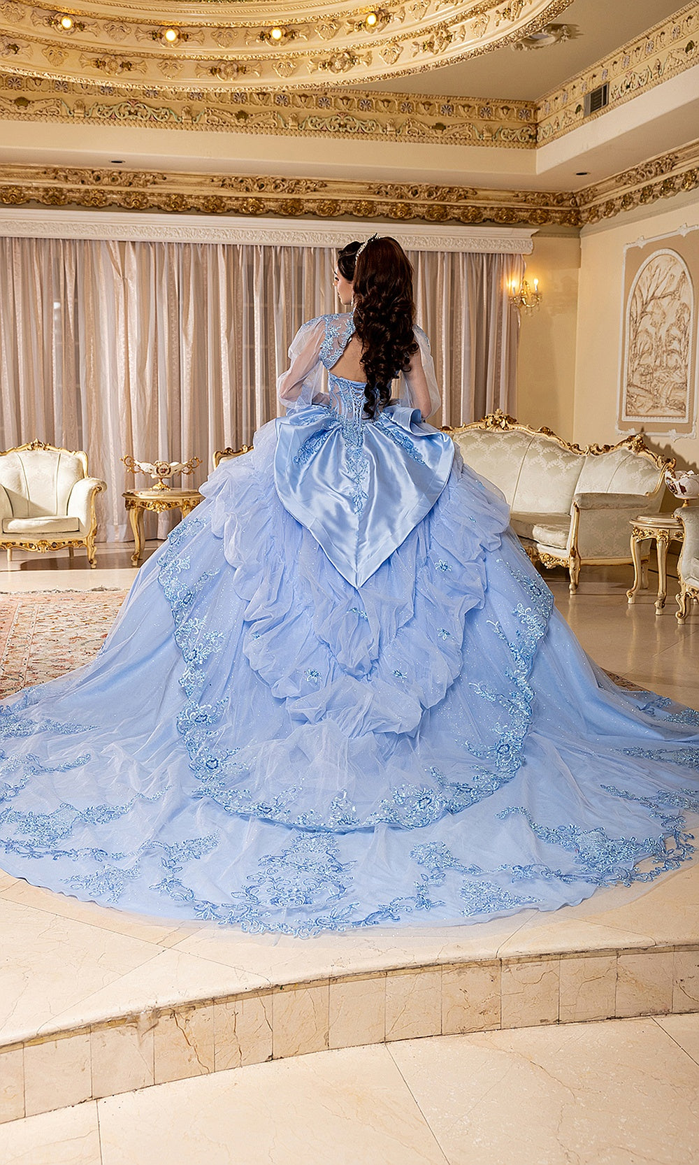May Queen LK299 dusty blue quinceañera gown — back view of the bow and dramatic glitter train